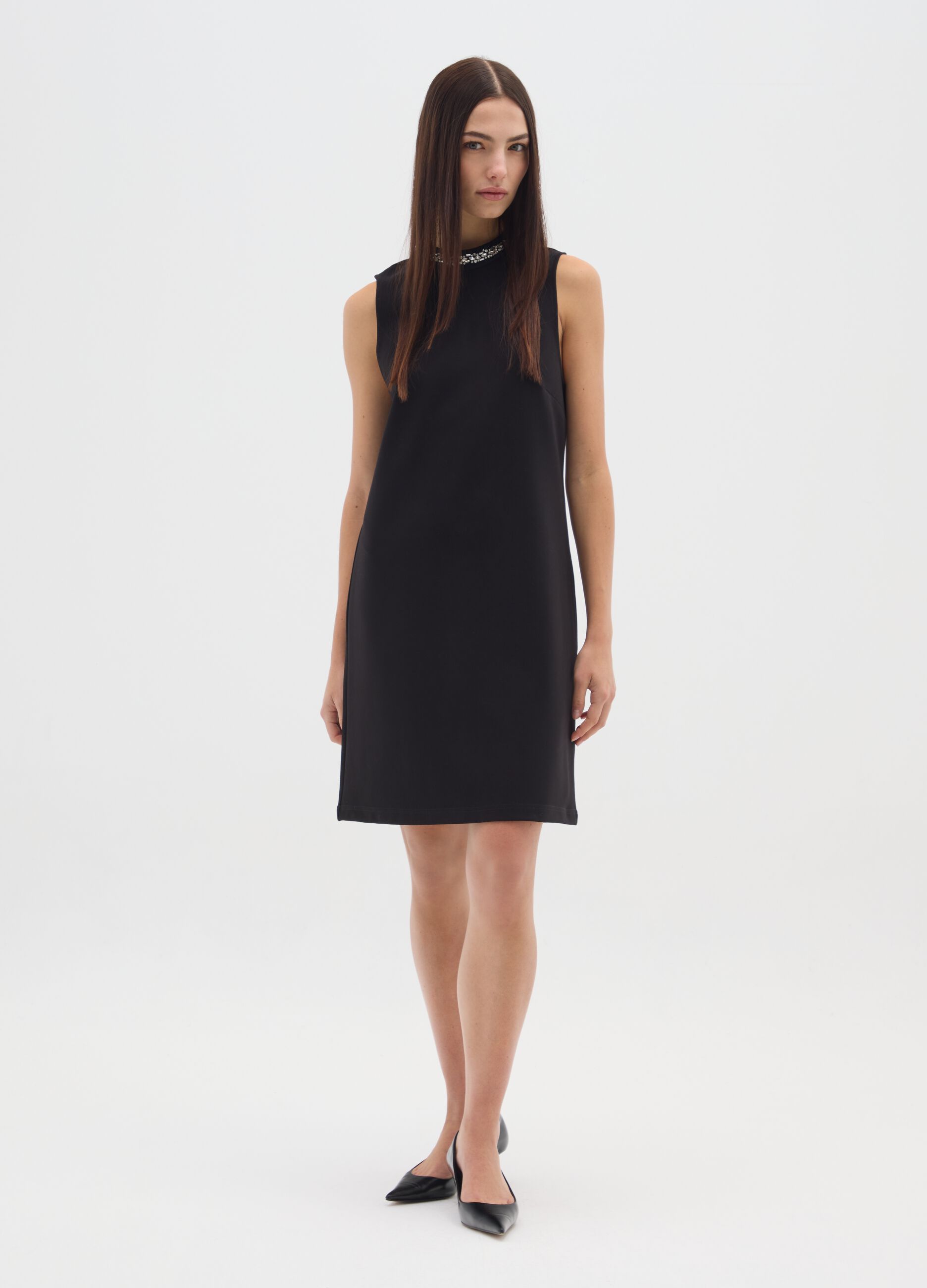 Sleeveless black fitted dress with embellished neckline