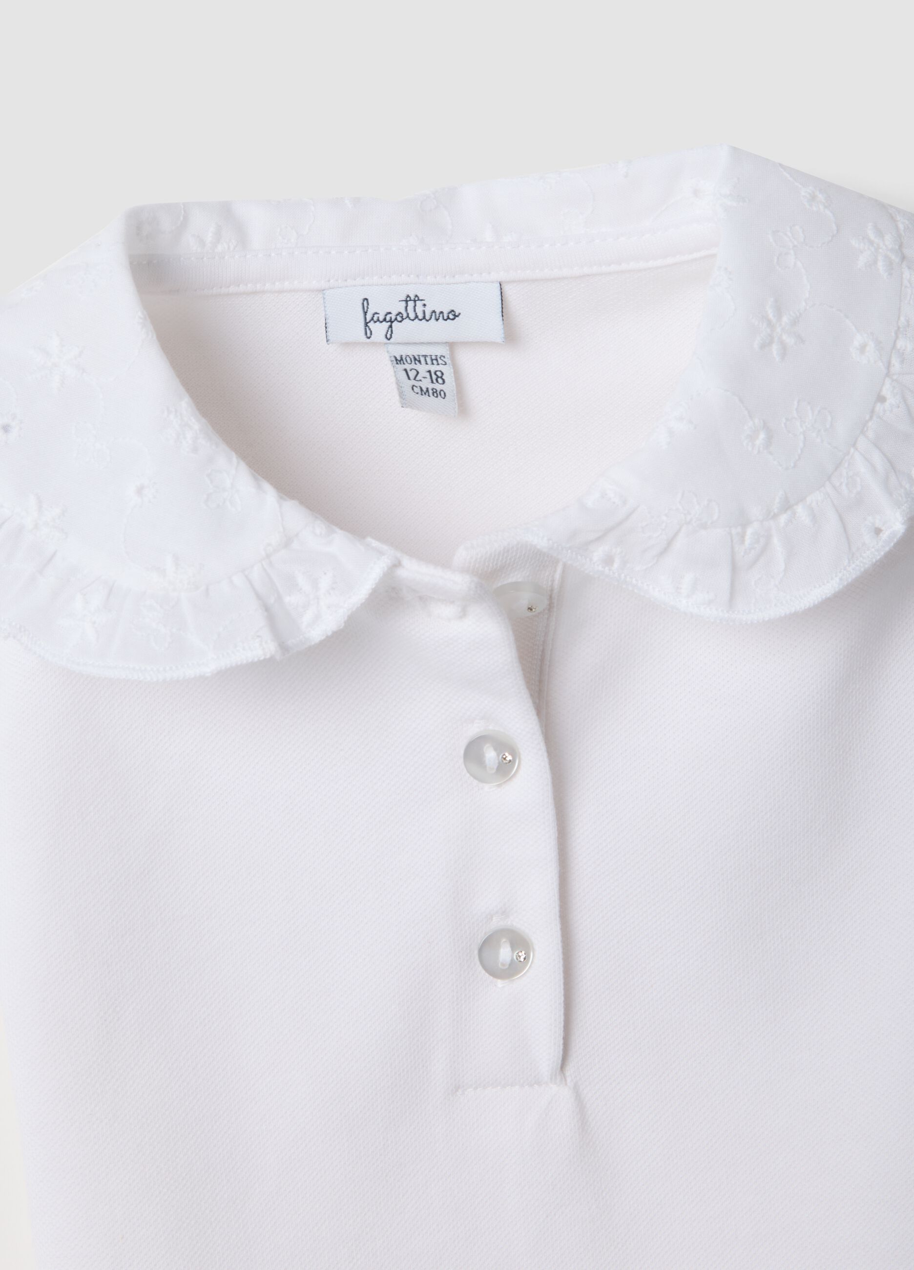 White short-sleeve stretch-cotton polo with ruffled collar
