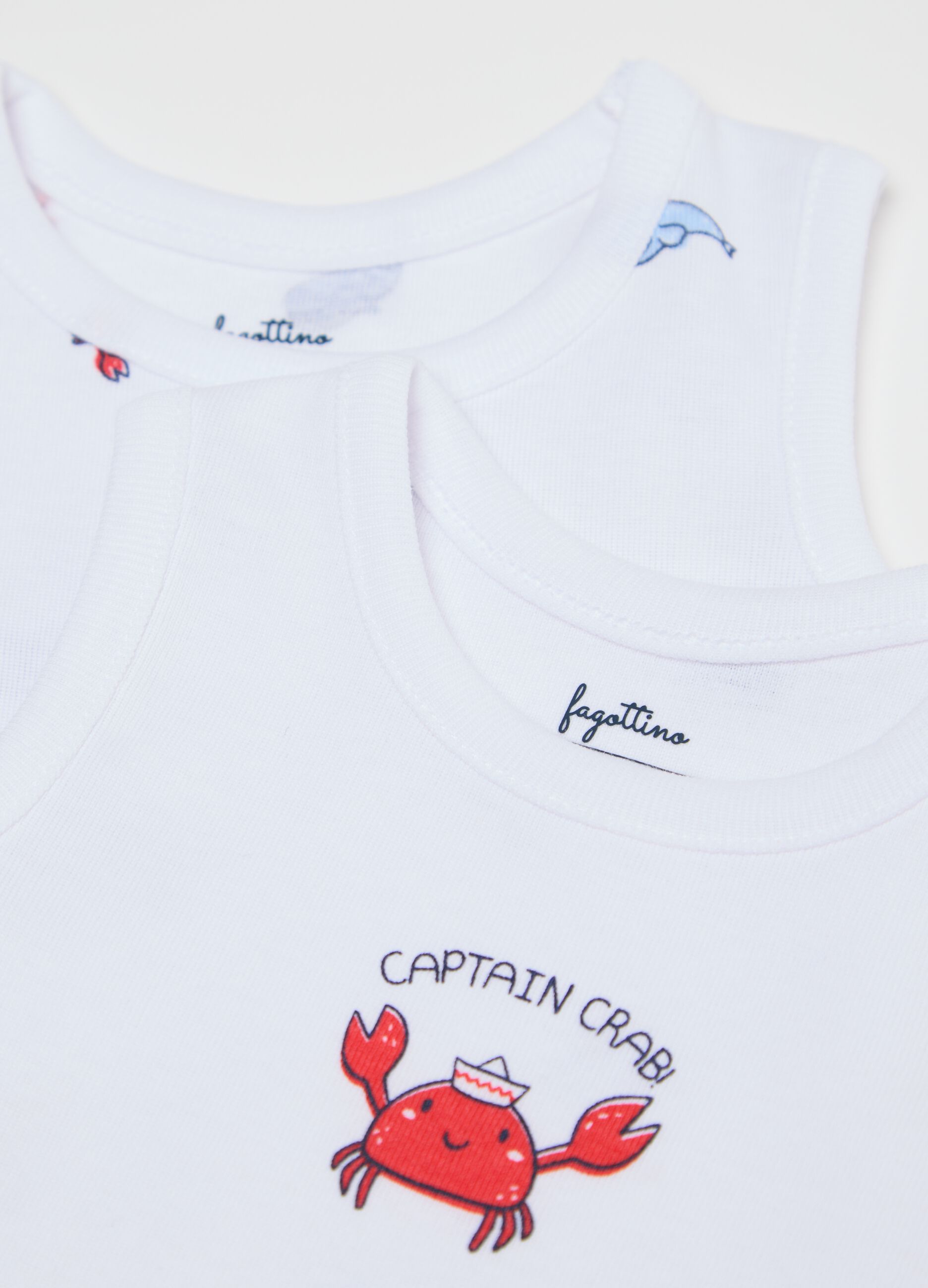 Three-pack white and light blue bodysuits in organic cotton with print