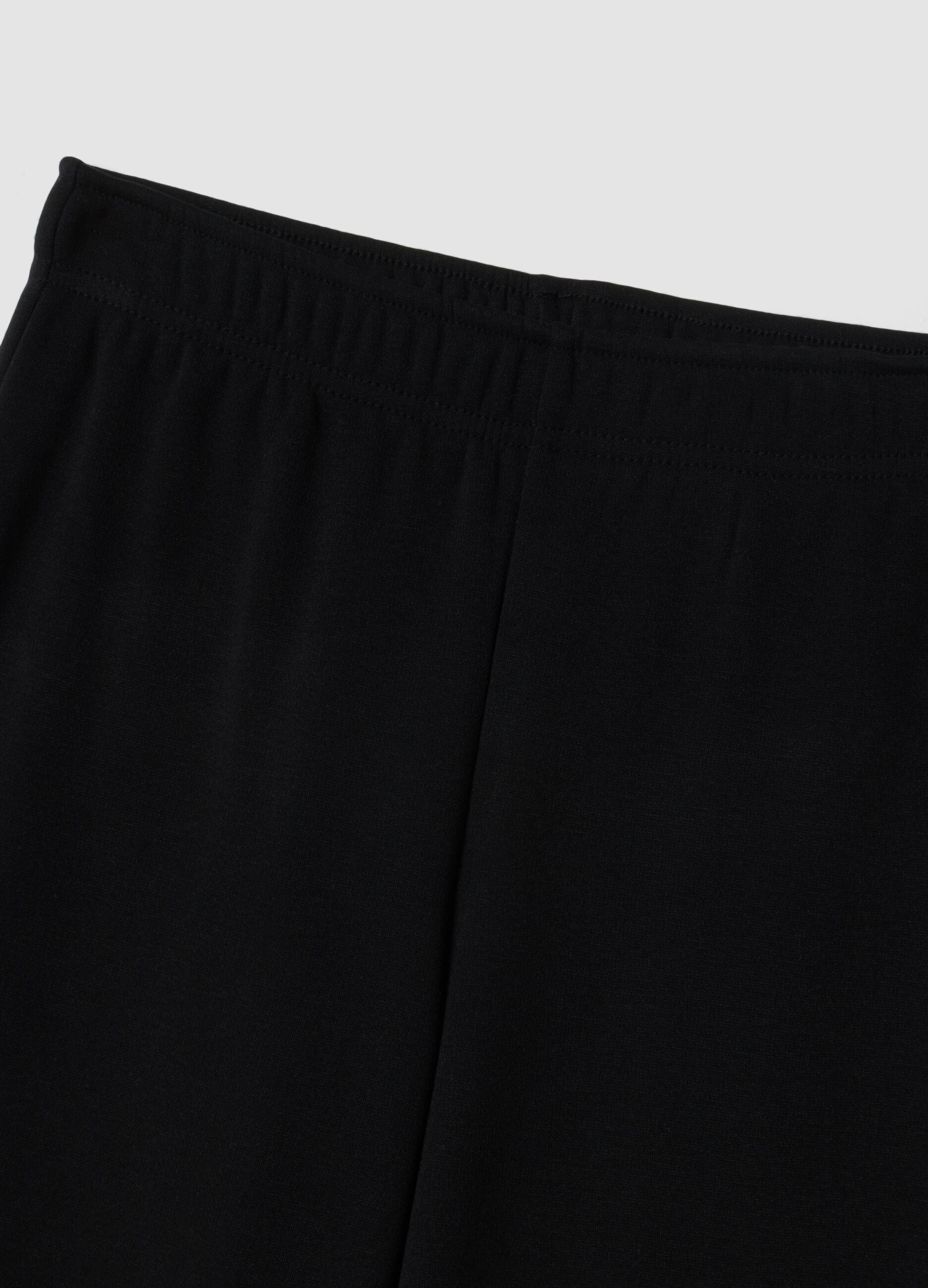 Pantaloni flare neri in viscosa elasticizzata con strass