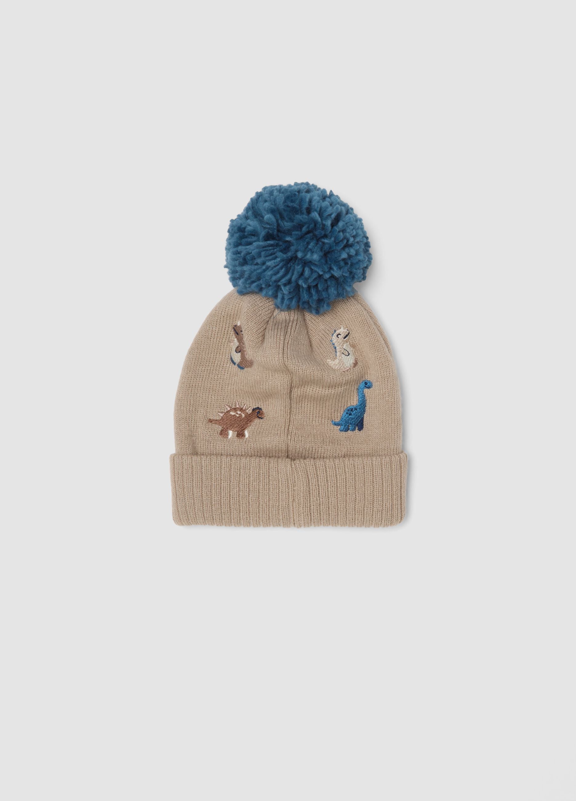 Beige hat with pom‑pom and dinosaurs