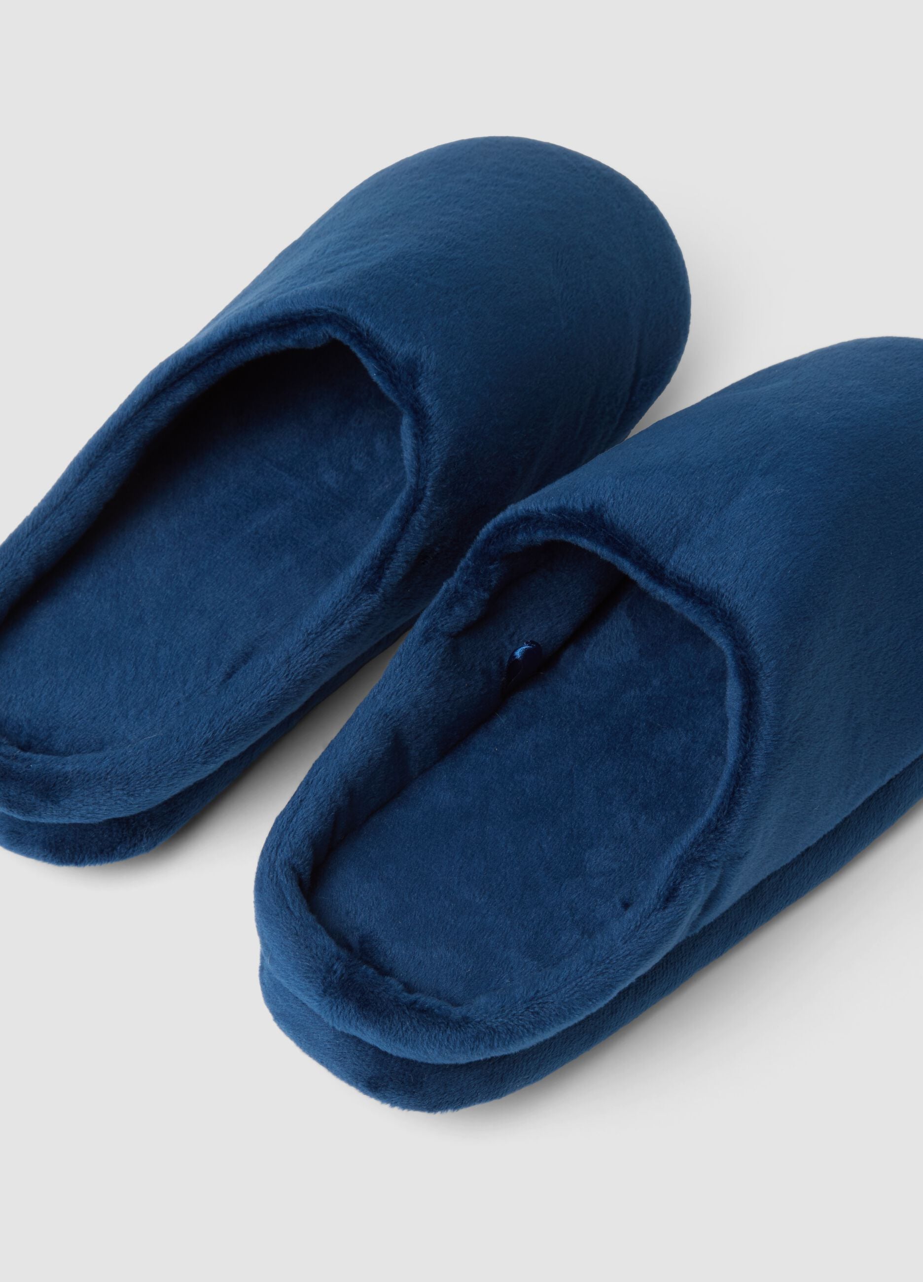 Blue closed-toe slippers with a soft-touch finish