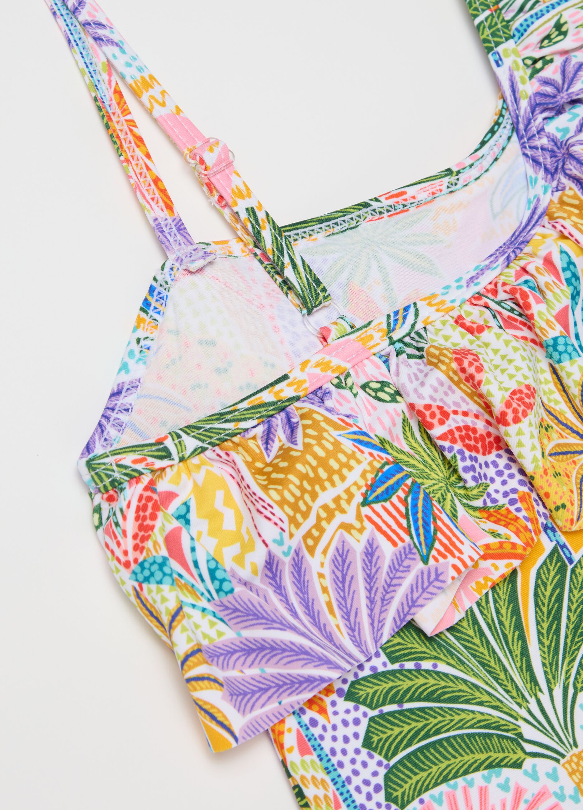 Yellow and purple swimsuit with flounce and tropical print