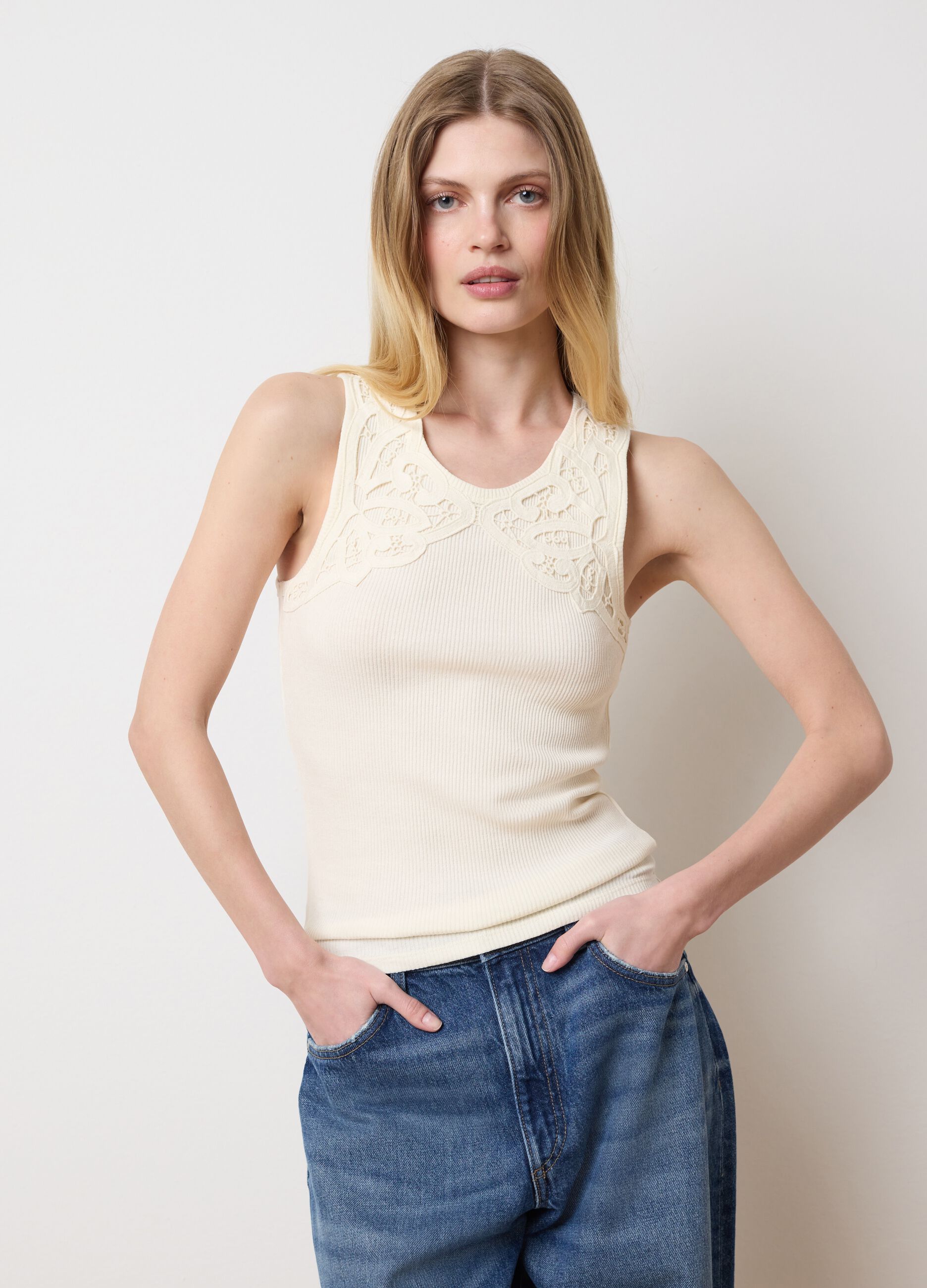 Ivory sleeveless top with embroidered details