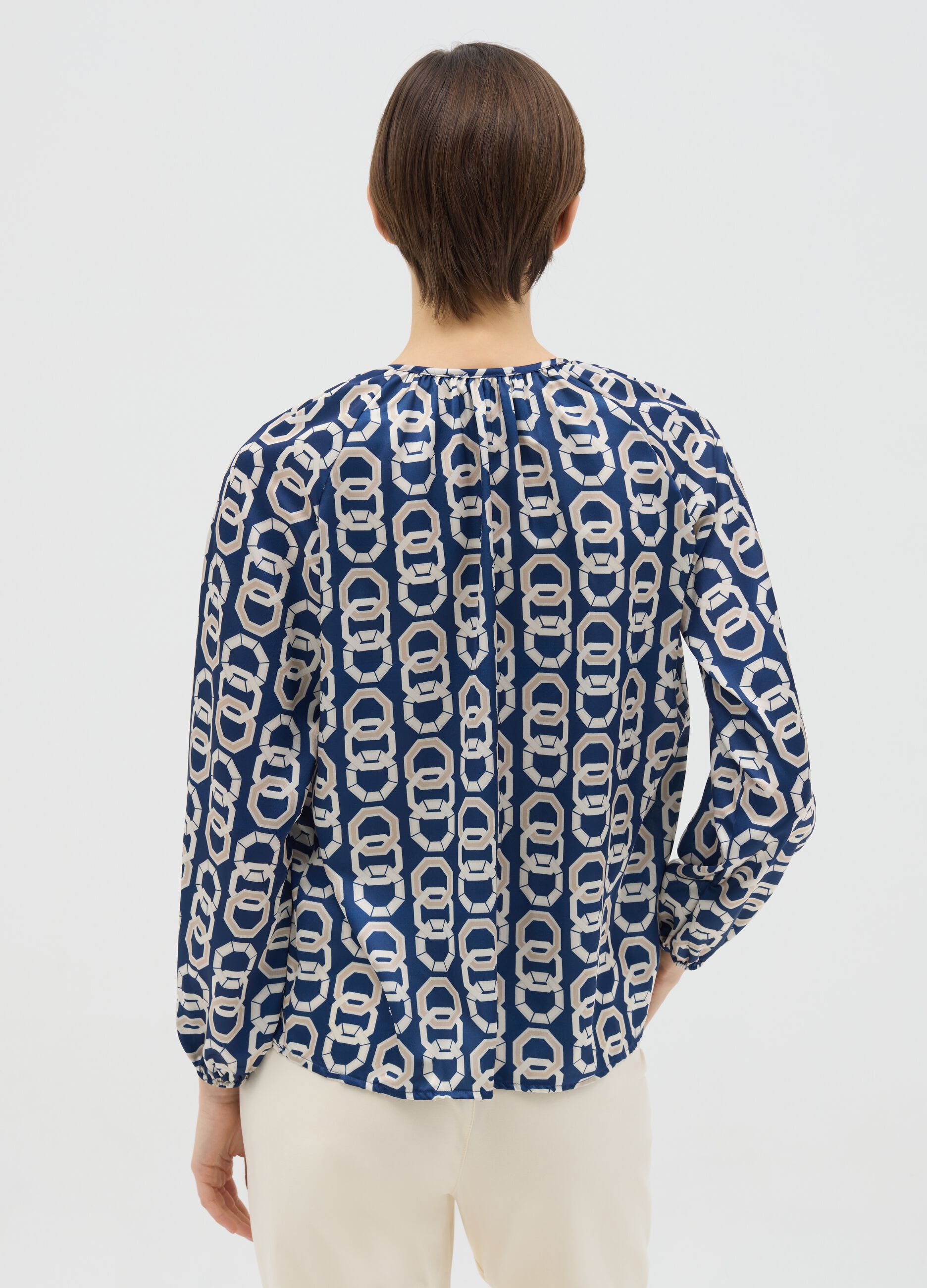 Blue long-sleeved blouse with geometric print
