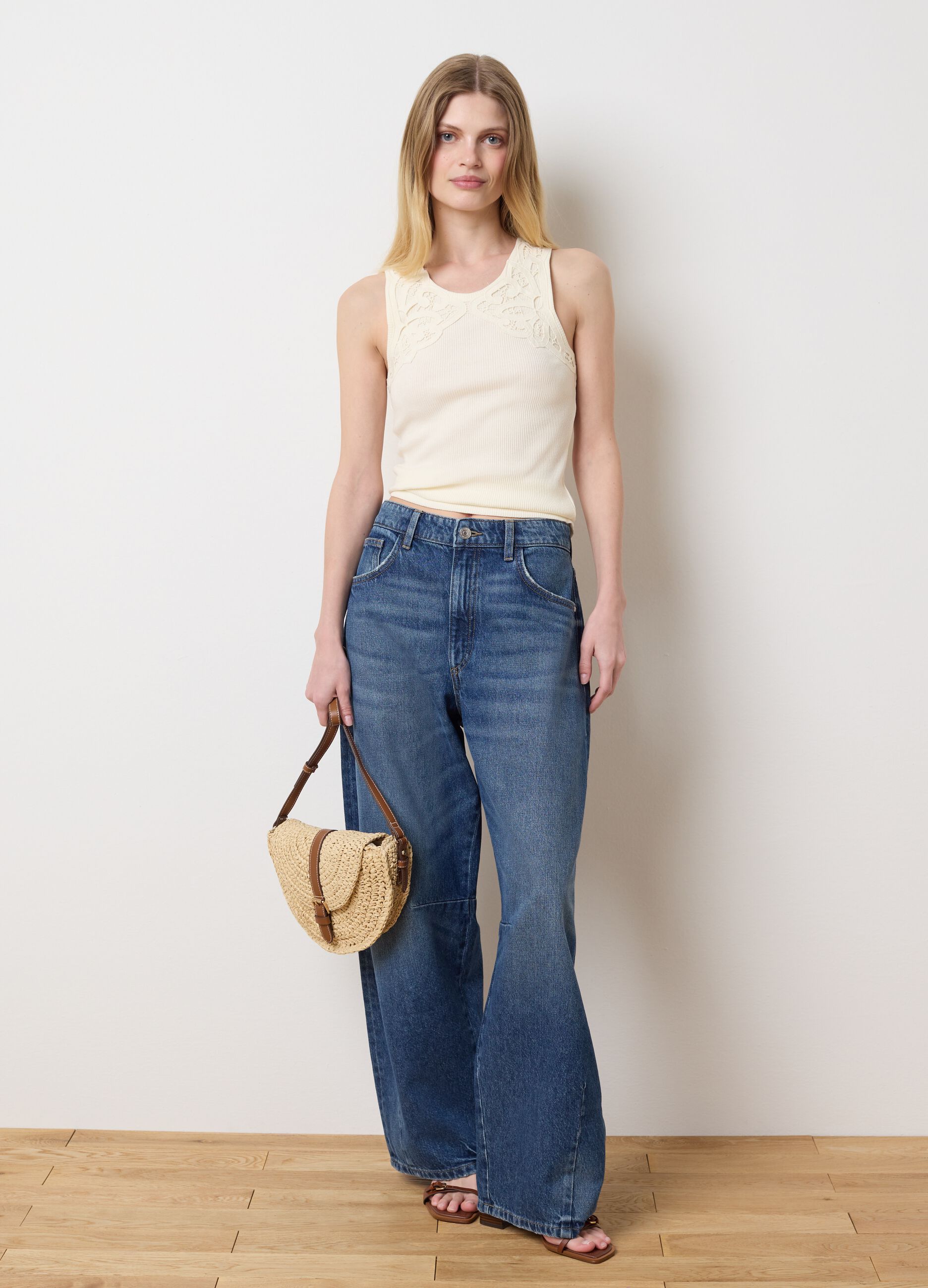 Ivory sleeveless top with embroidered details