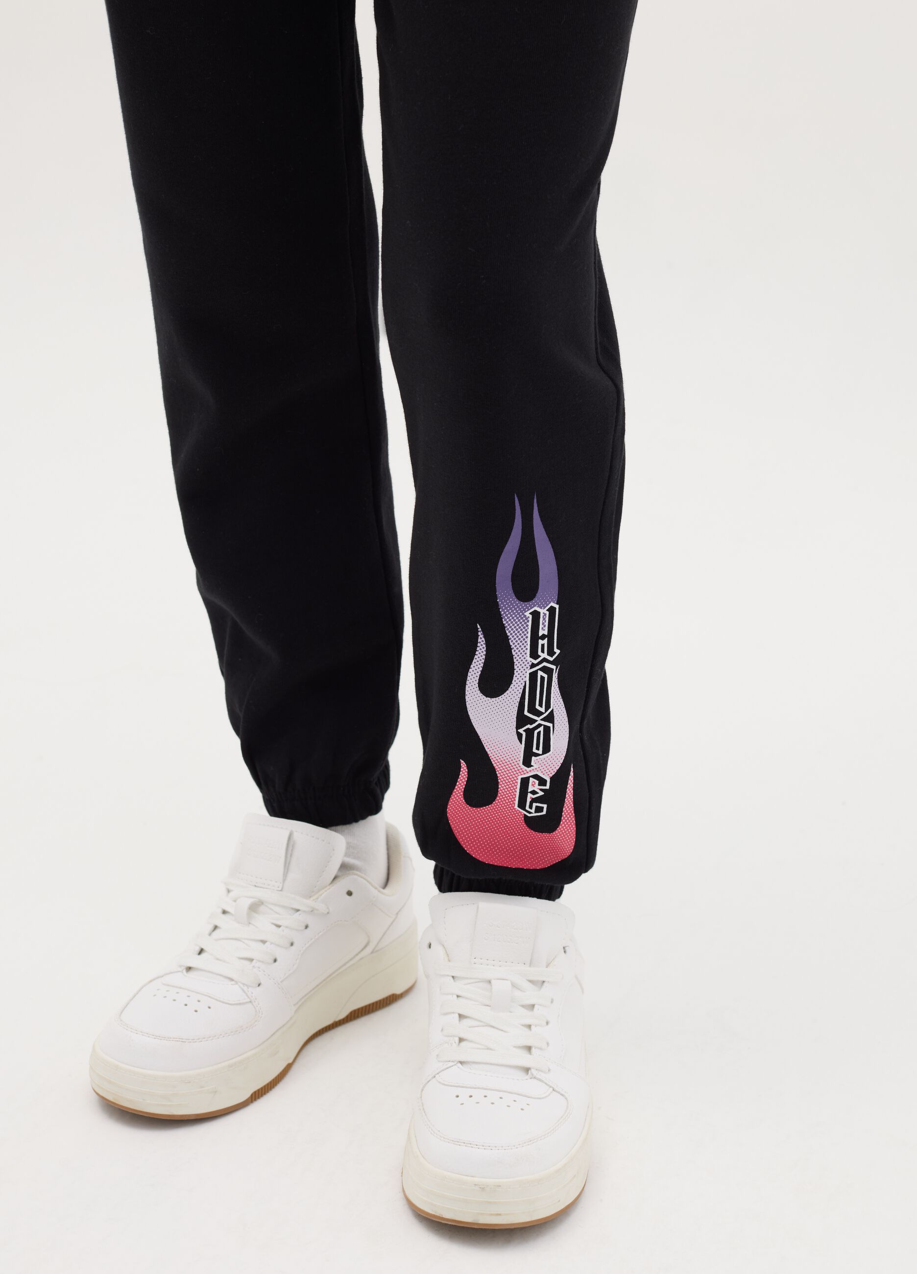Joggers with drawstring and "Hope” flame print