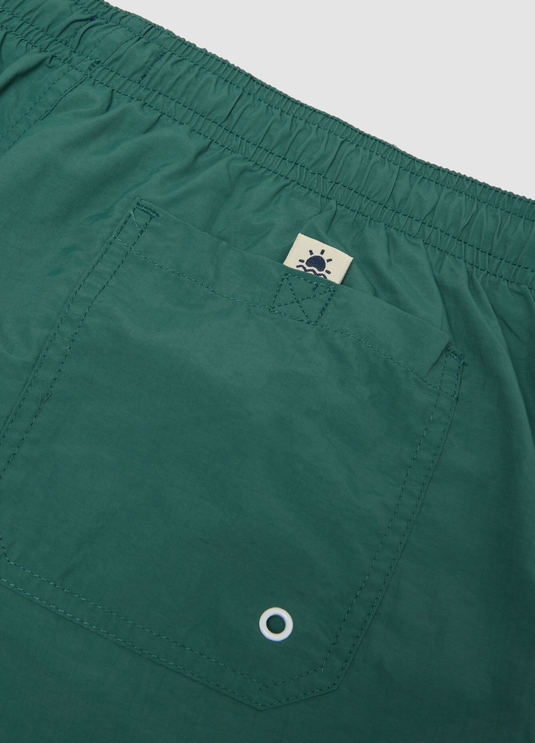 Green swim shorts with elasticated waist