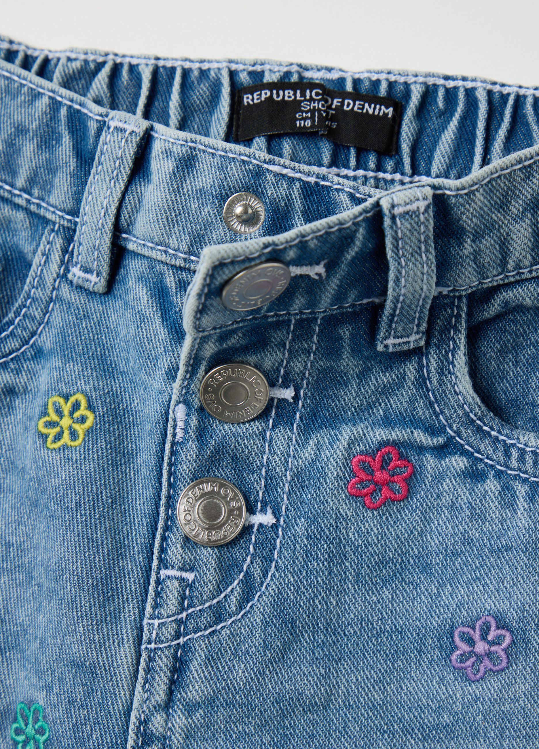 Light blue denim shorts with floral embroidery