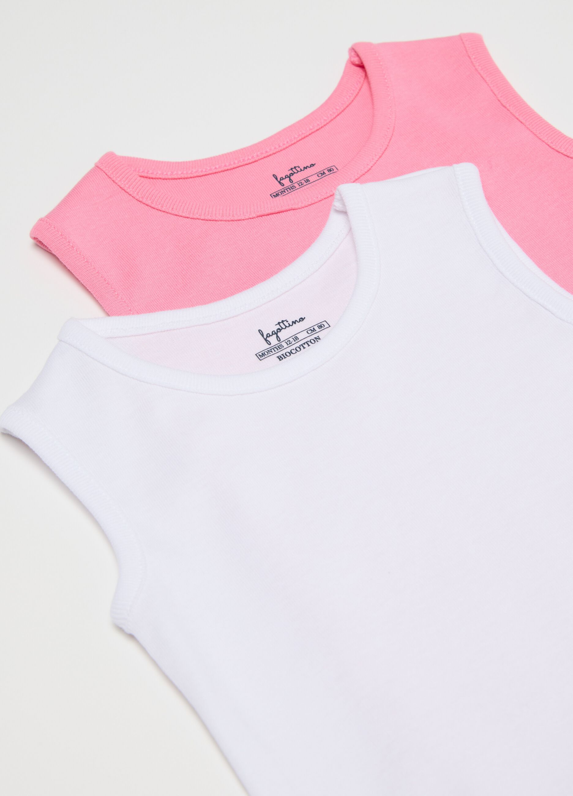 Three-pack pink and white sleeveless bodysuits in organic cotton