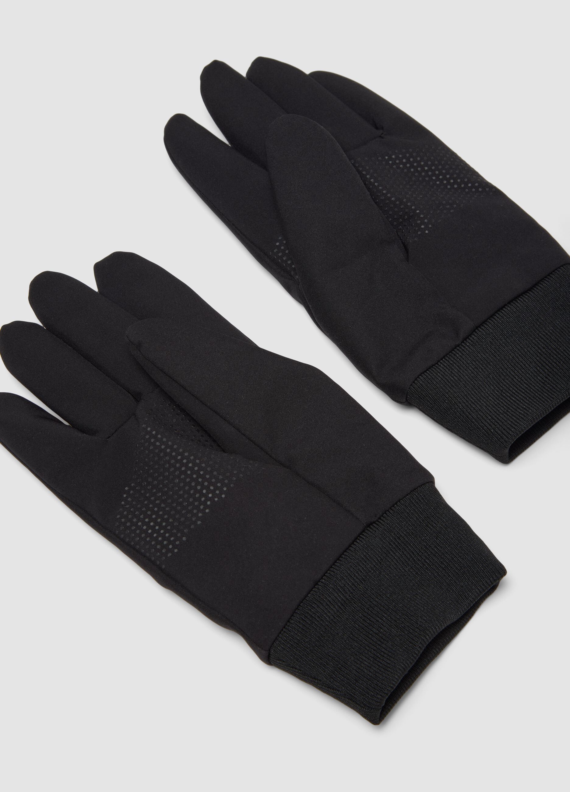 Black gloves with ribbed cuffs and non-slip grips