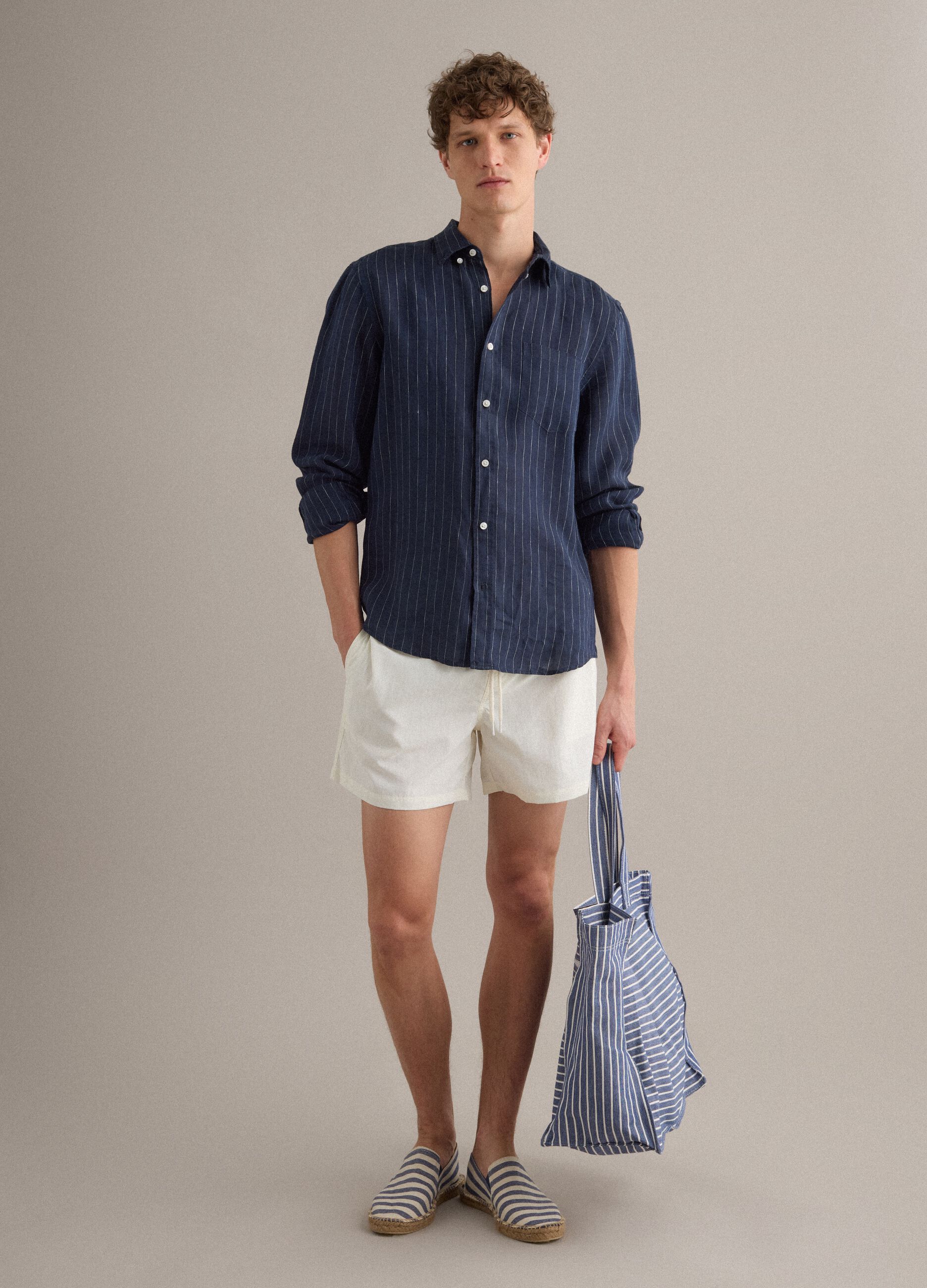 White swim shorts with elasticated waistband and drawstring