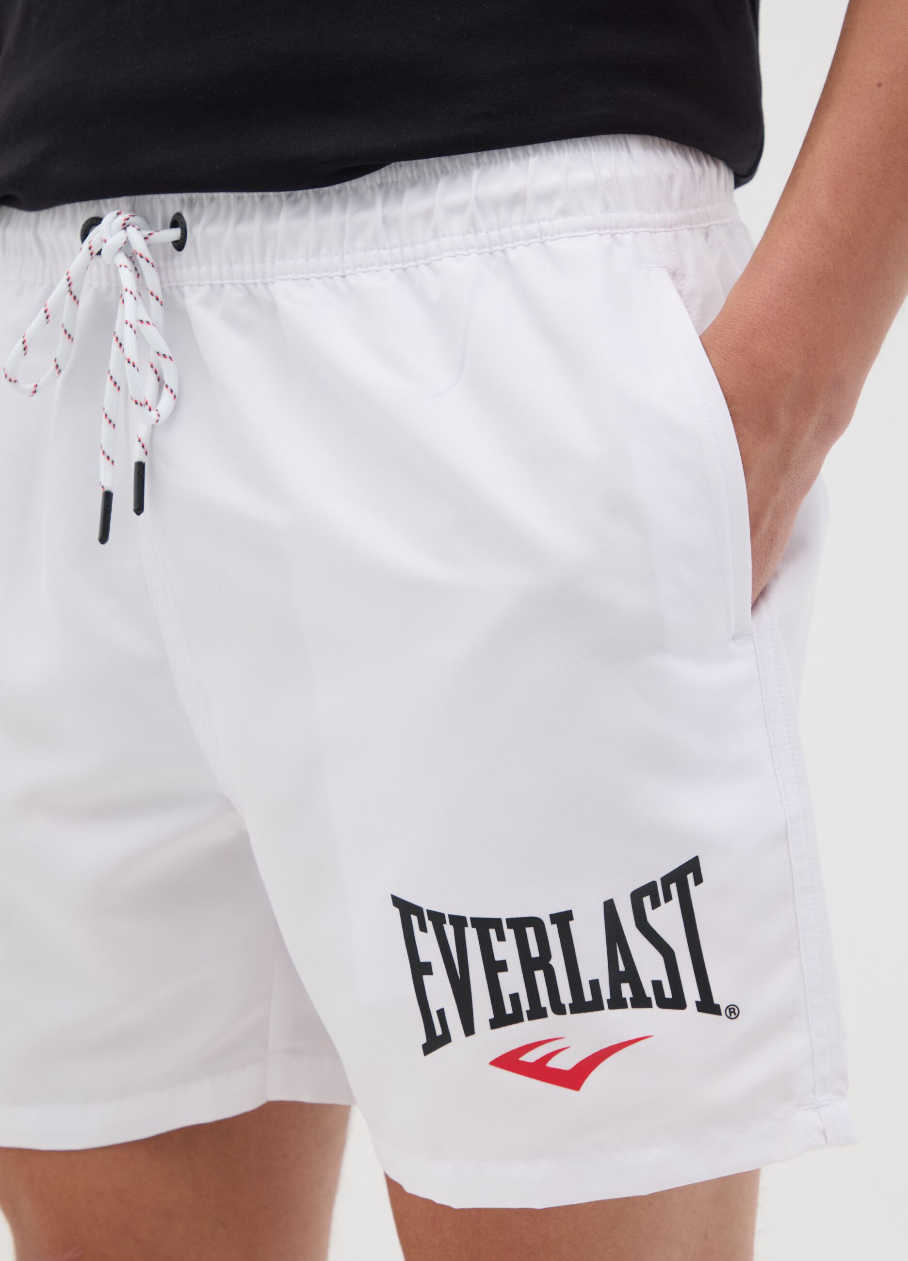 White swimming trunks with logo print