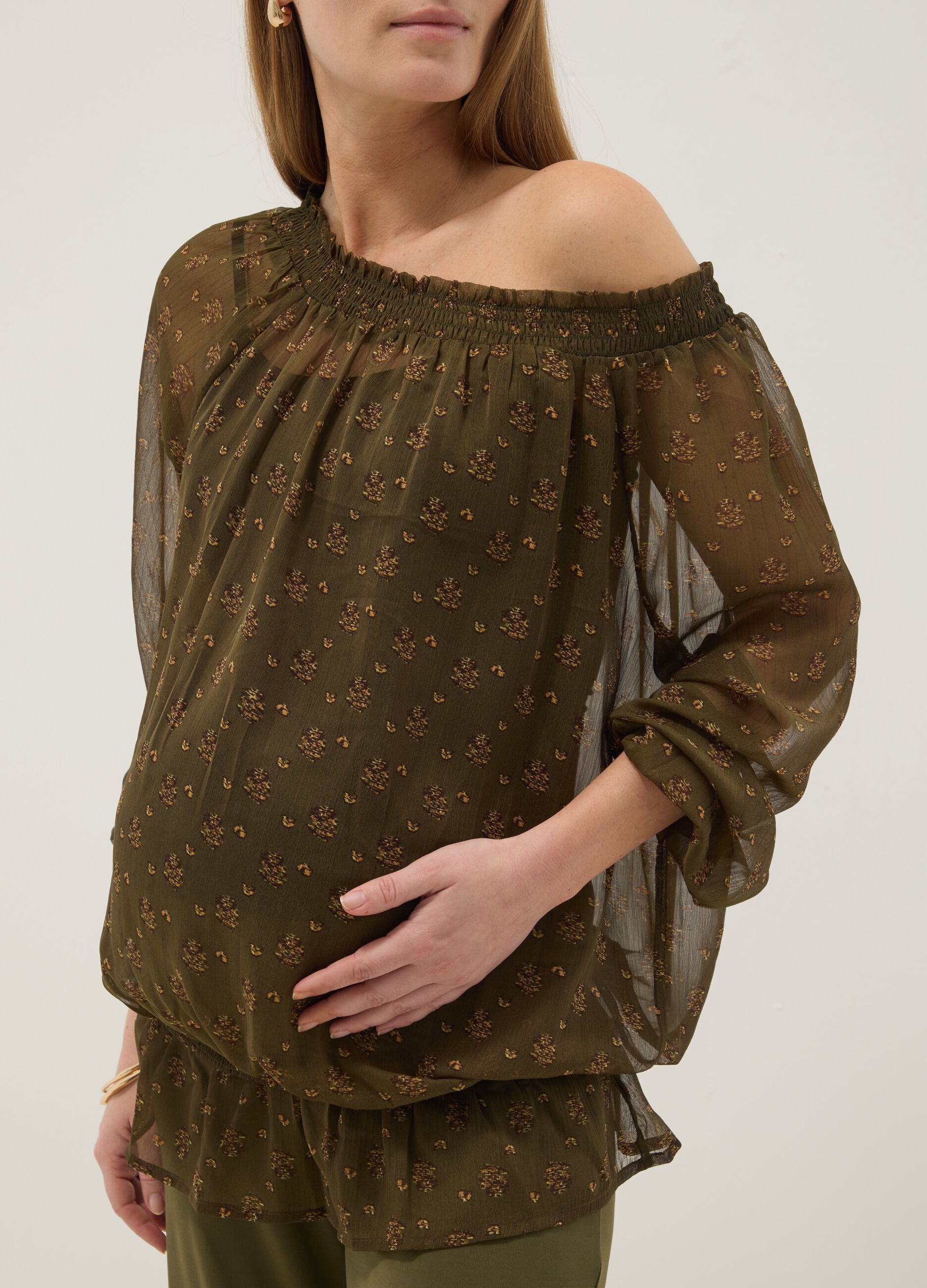 Green maternity blouse with boat neckline and fantasy print