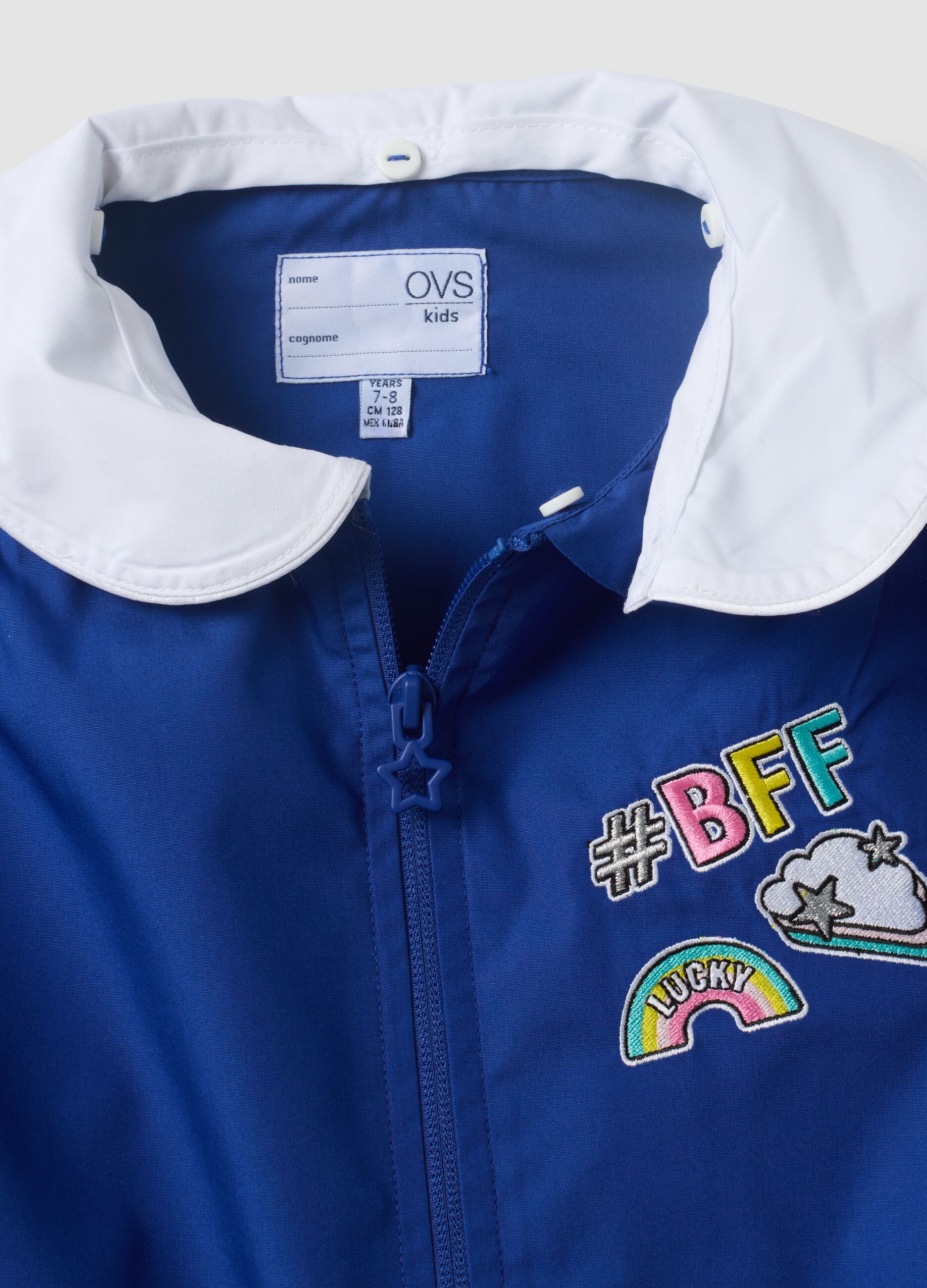 Blue girls&rsquo; school apron with rainbow embroidery
