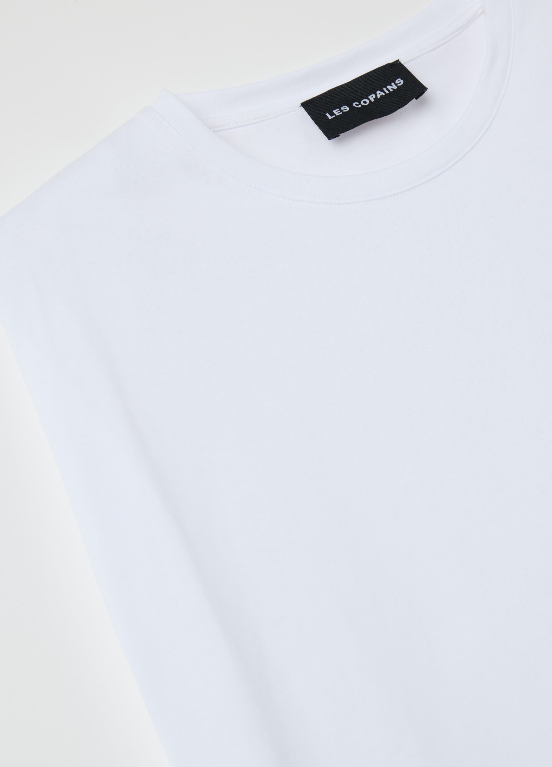 White sleeveless boxy-fit T-shirt with spaghetti straps