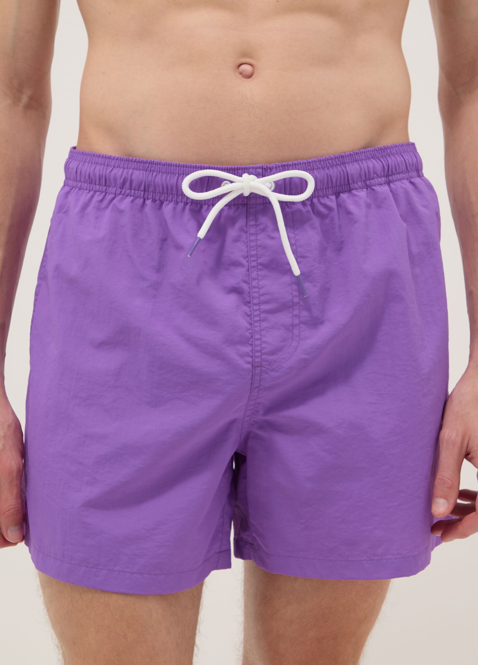 Purple swim shorts with elasticated waistband