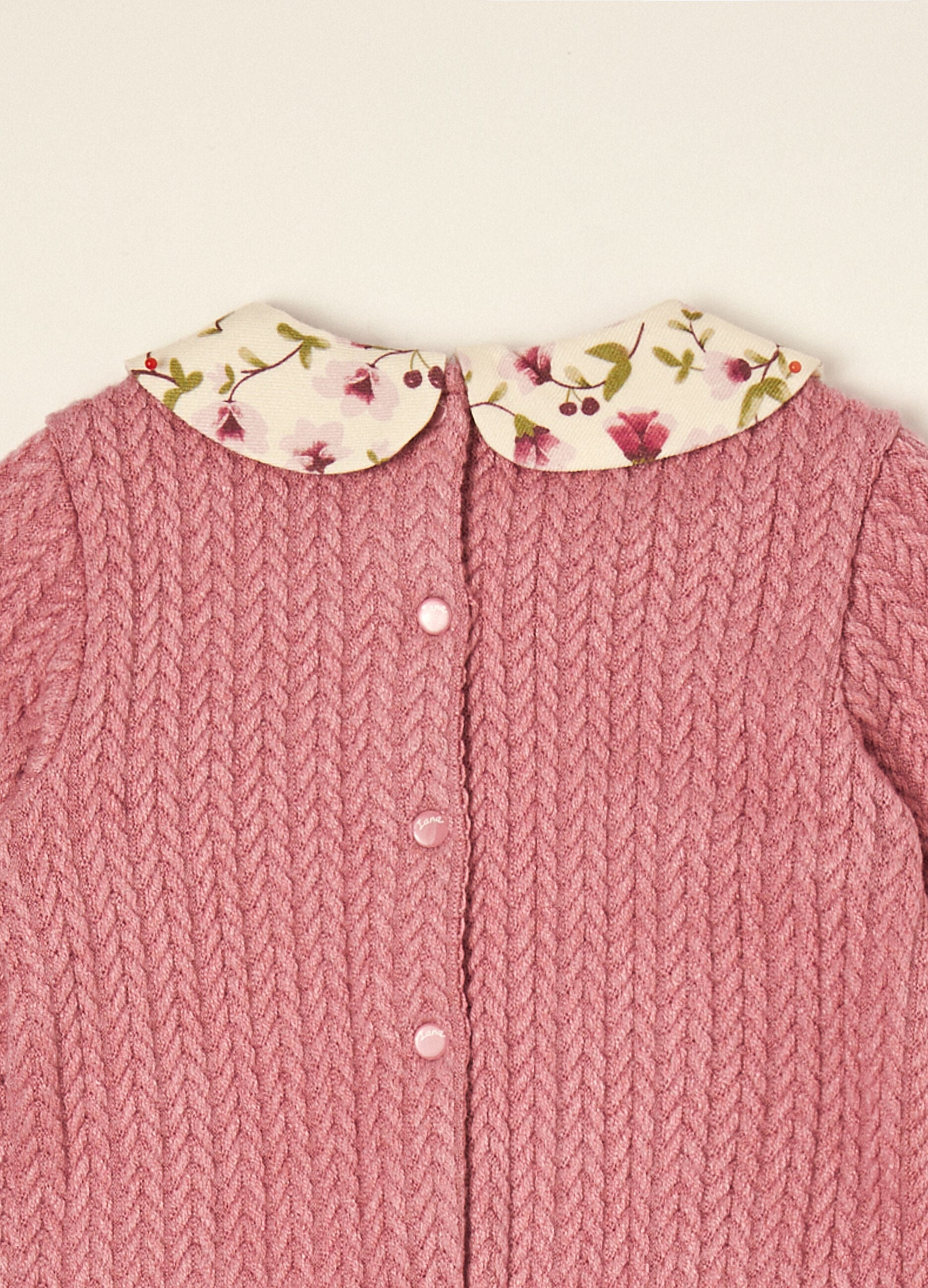 Pink stretch viscose baby sleepsuit with floral collar