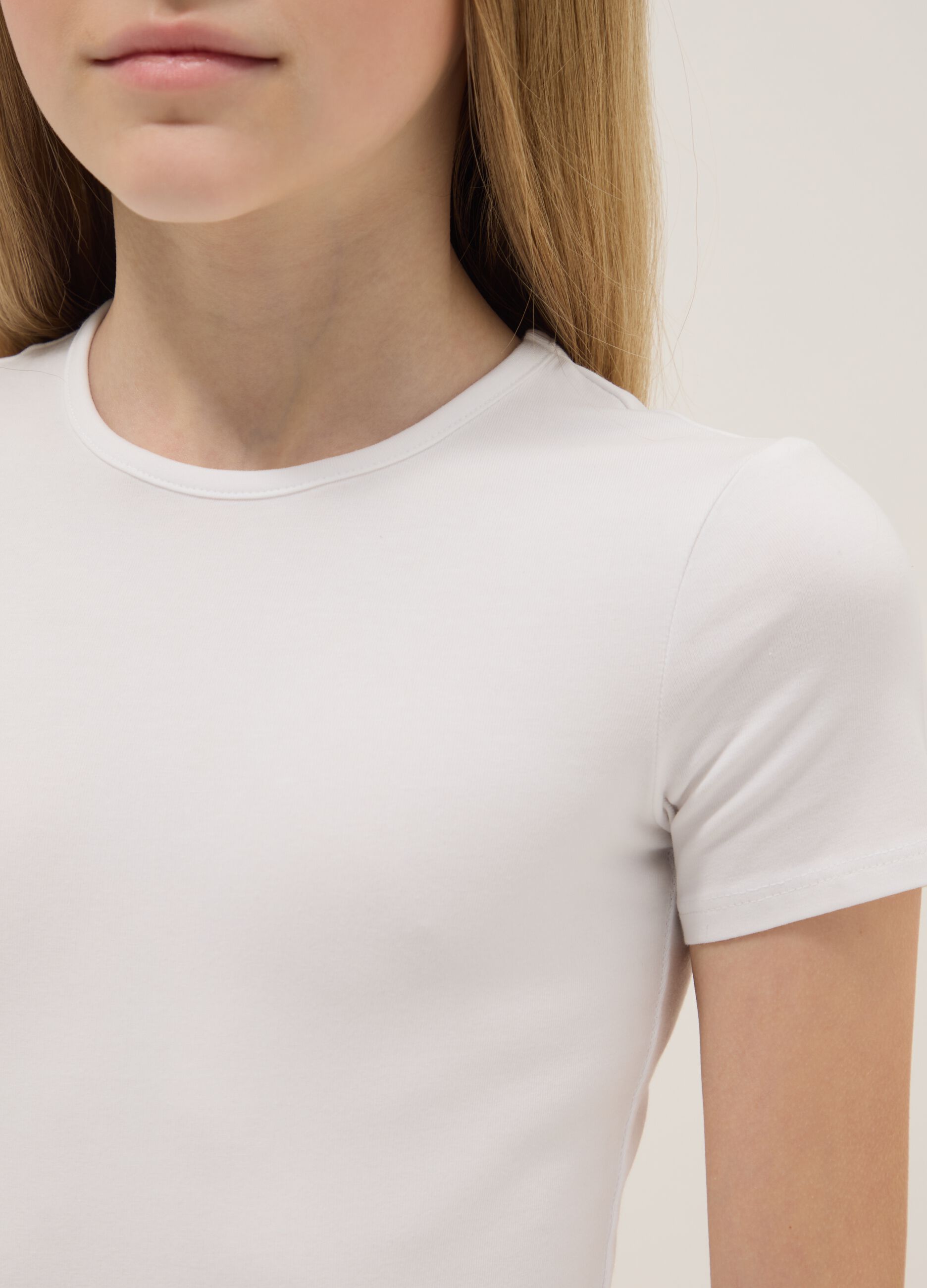 Girl's fitted white stretch cotton bodysuit