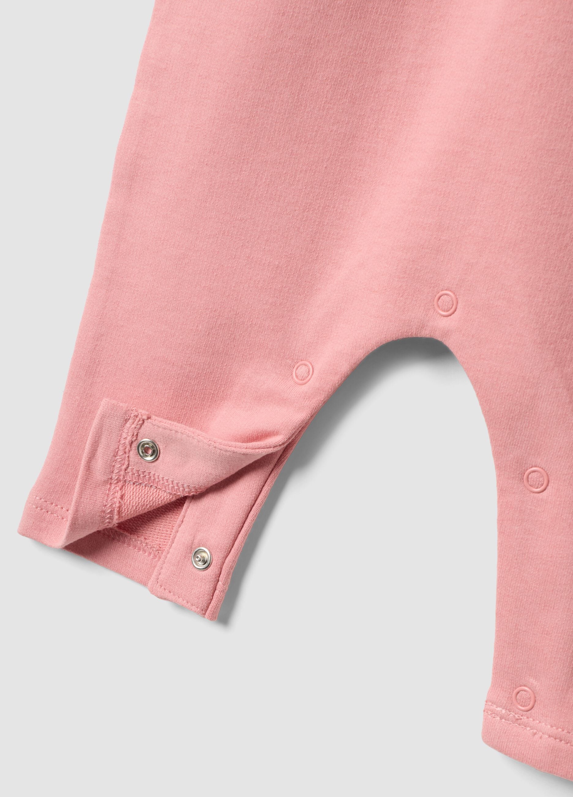 Pink organic cotton romper with ruffle for baby girl