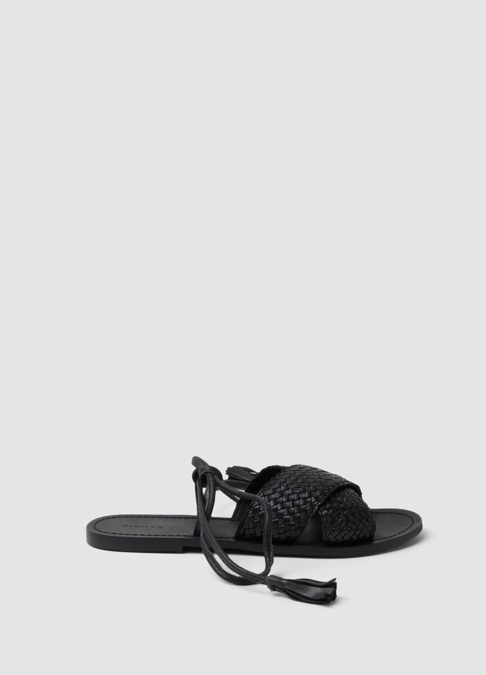 Black woven sandals with ankle ties