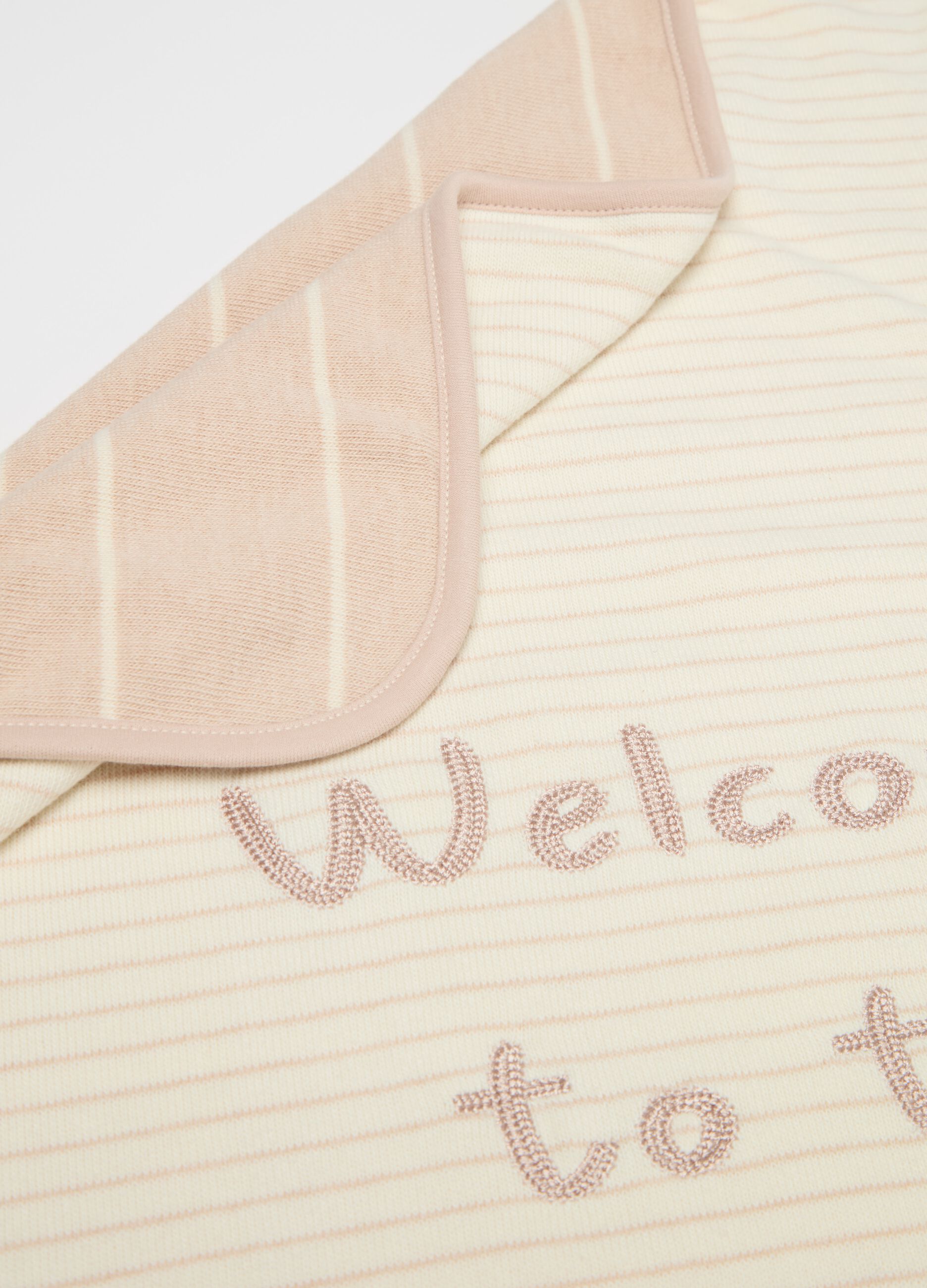 Blanket with "Welcome To The World" embroidery