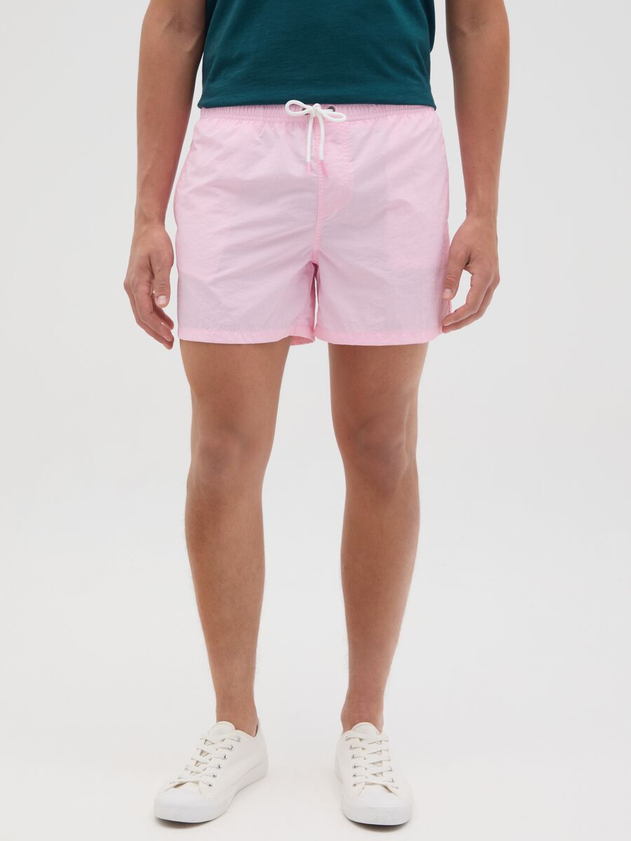 Pink swim trunks in mixed materials_1