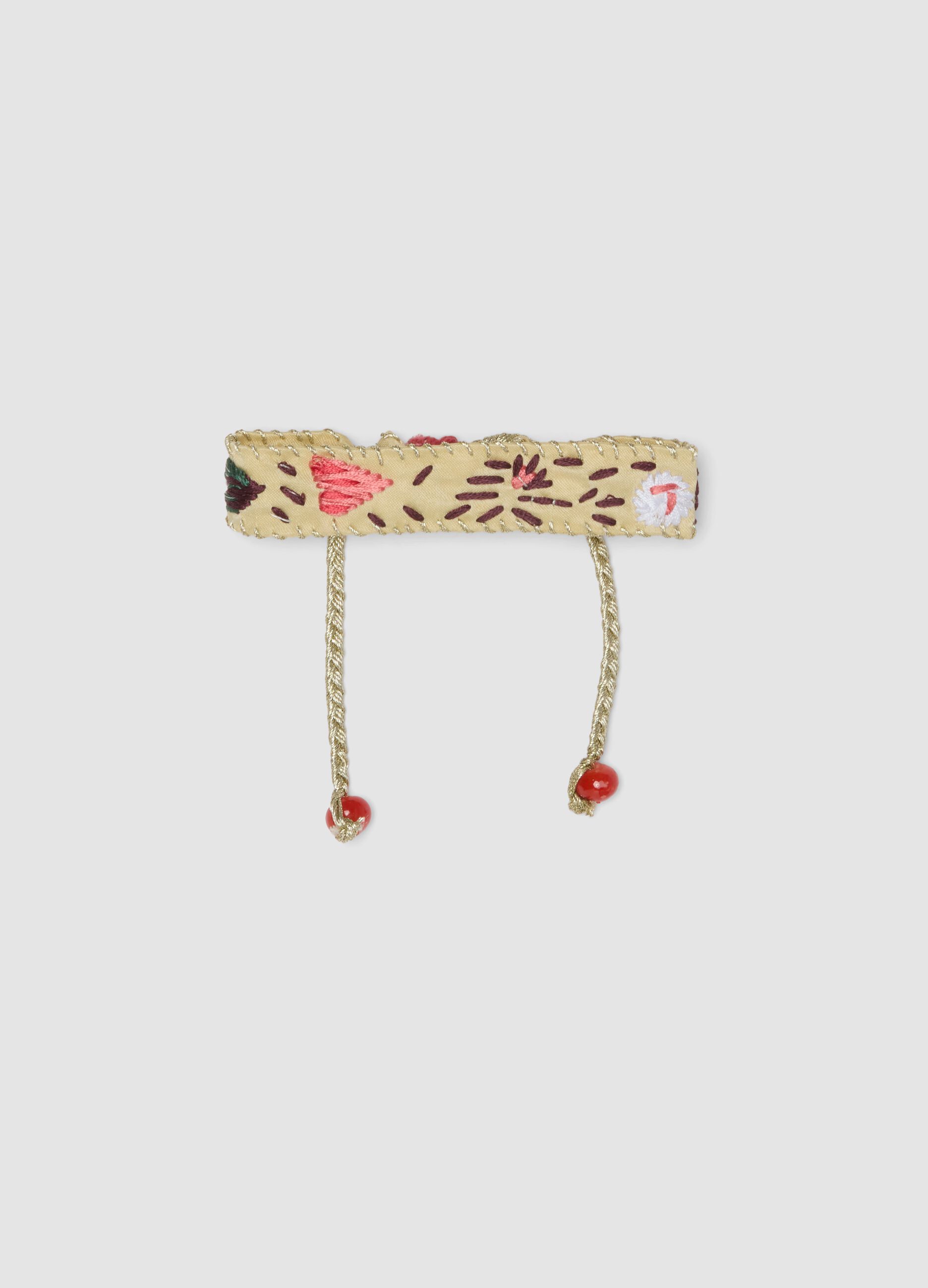 Beige embroidered bracelet with adjustable tie cords