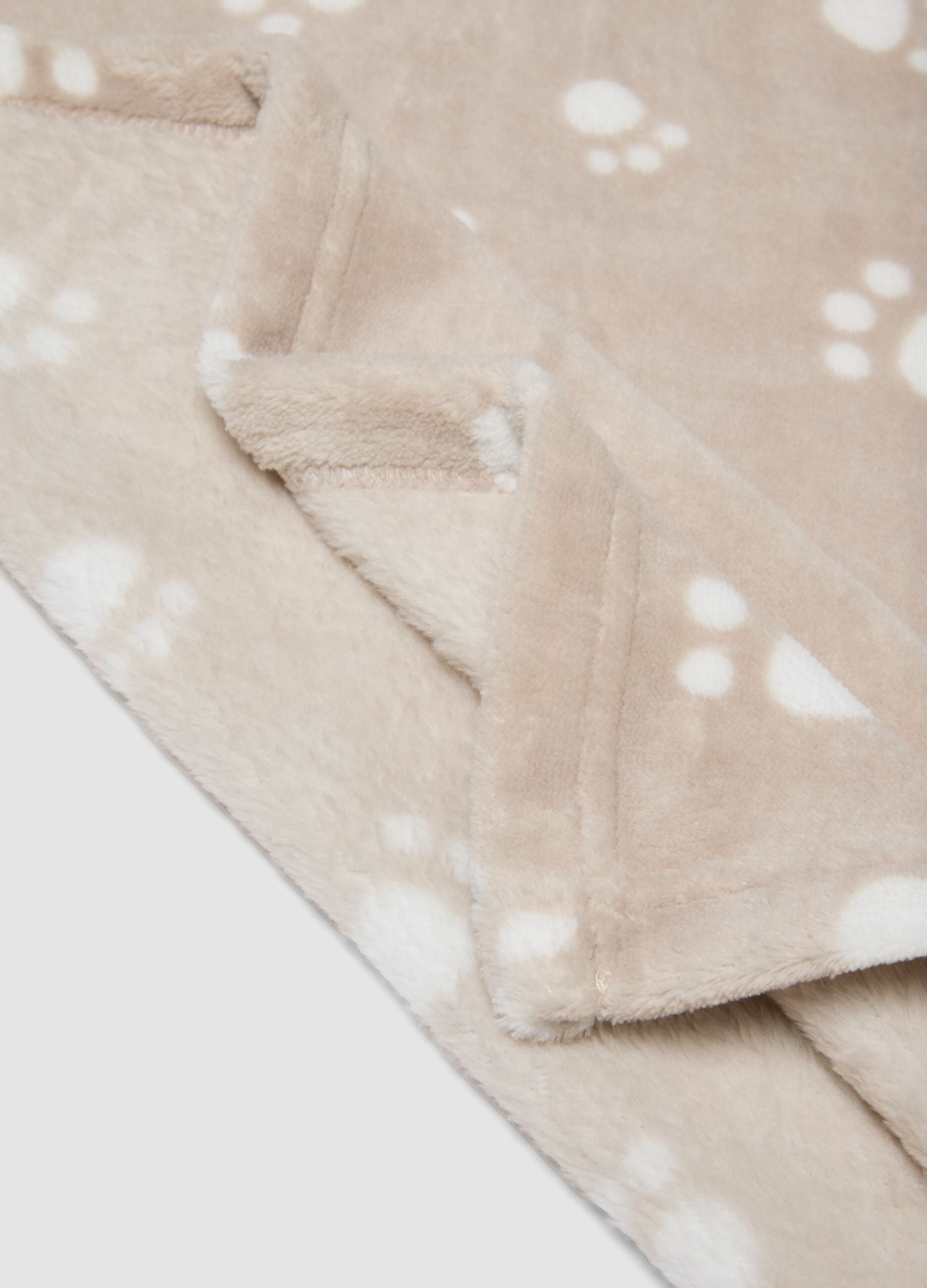 Copertina beige con stampa zampette per neonati
