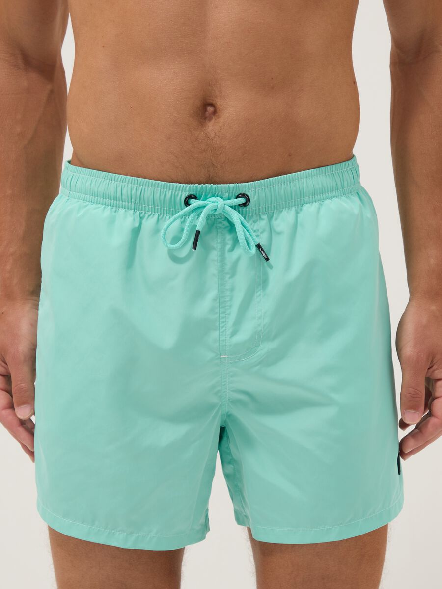 Light blue swim shorts with drawstring waist_2