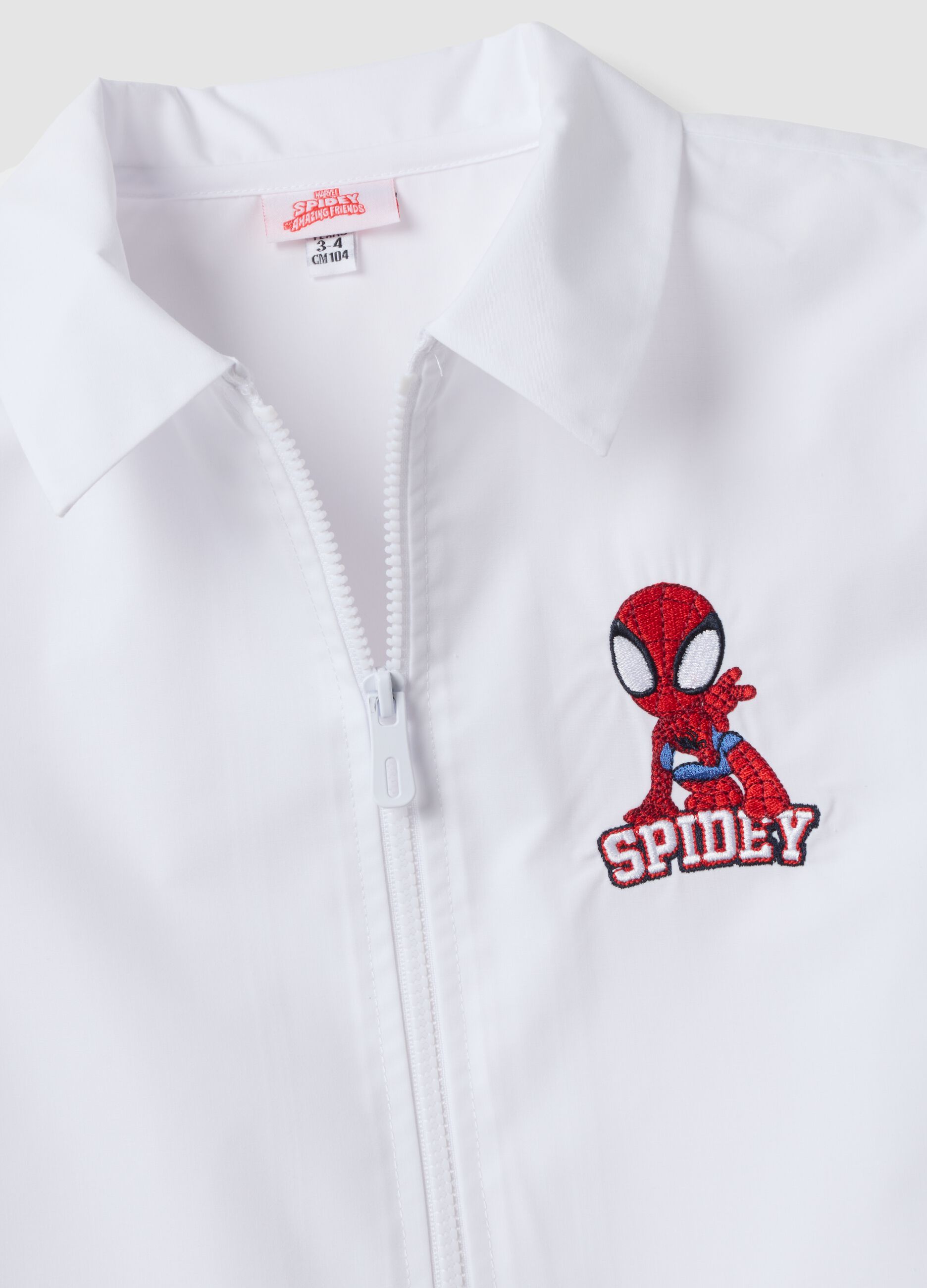 White nursery apron for boys with zip and Spidey embroidery