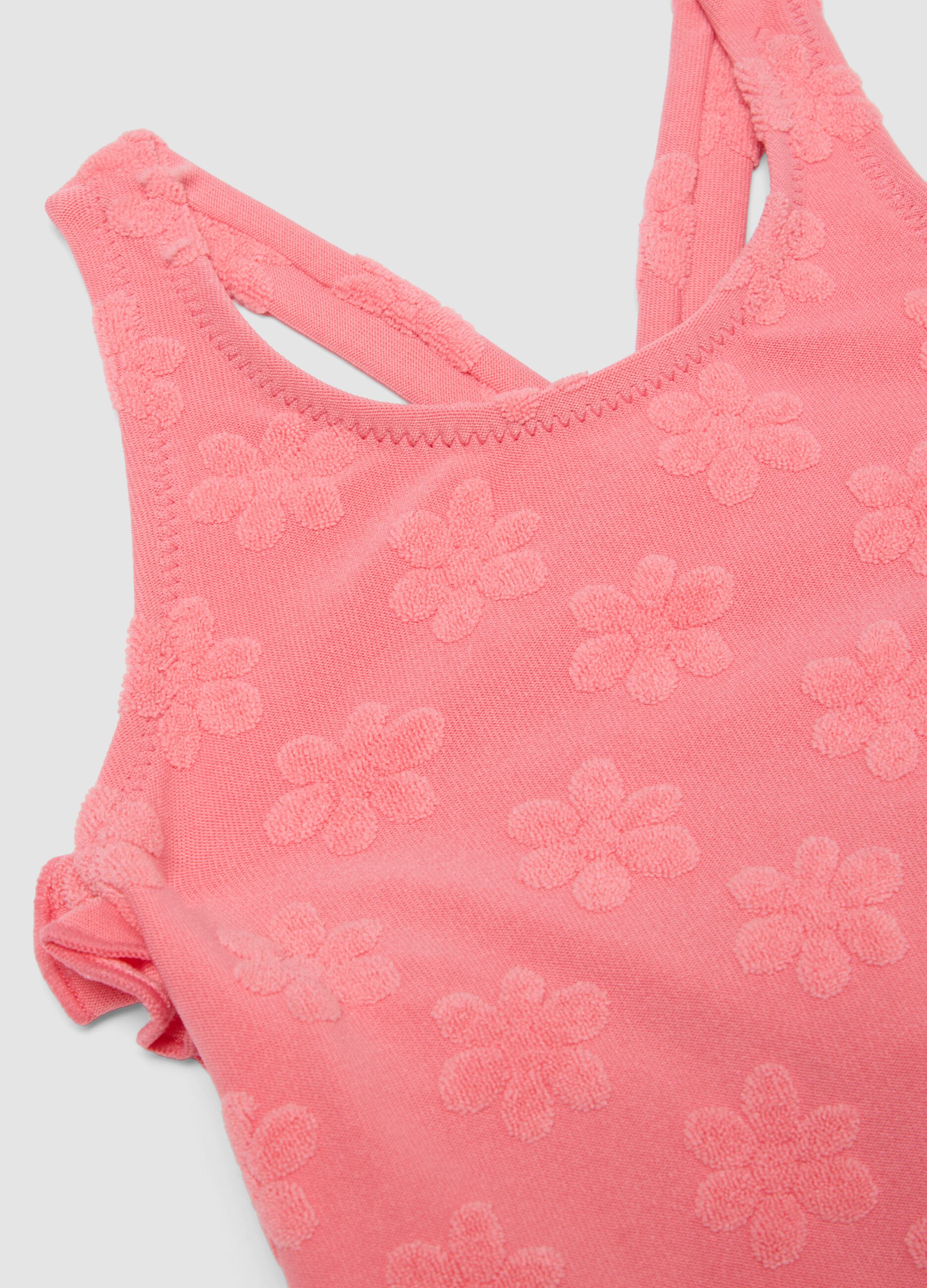 Pink stretch-fabric one-piece swimsuit for baby girls with floral detailing