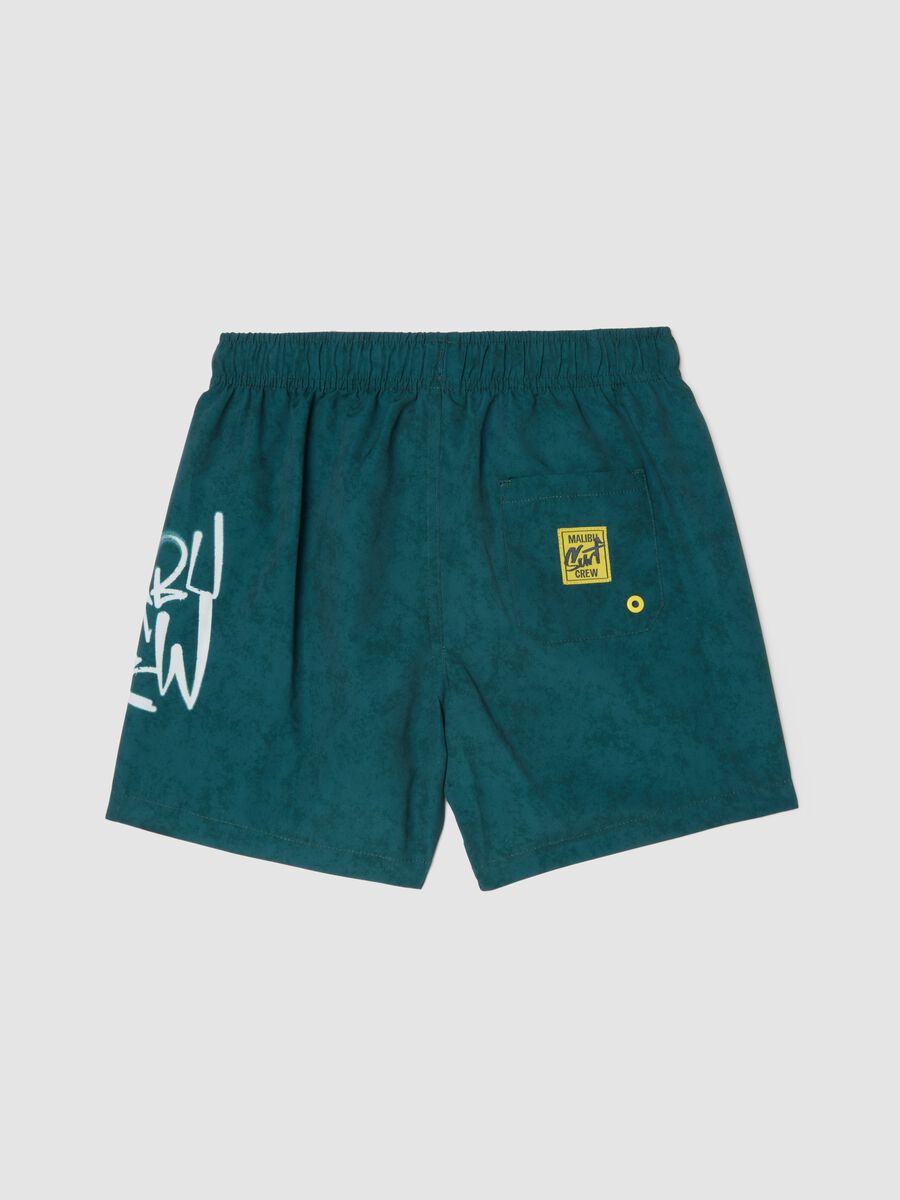 Green swim shorts with graphic print_1