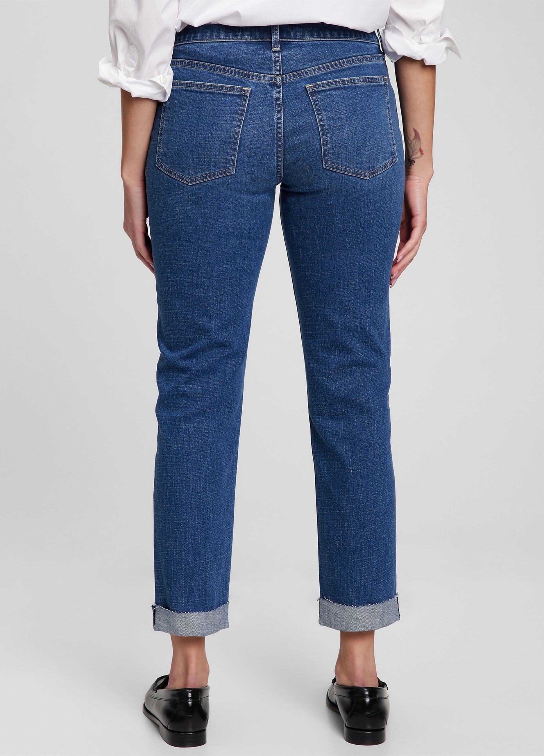 Girlfriend jeans with abrasions and raw edged hem