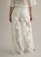 White wide leg cotton blend trousers with perforated texture_3