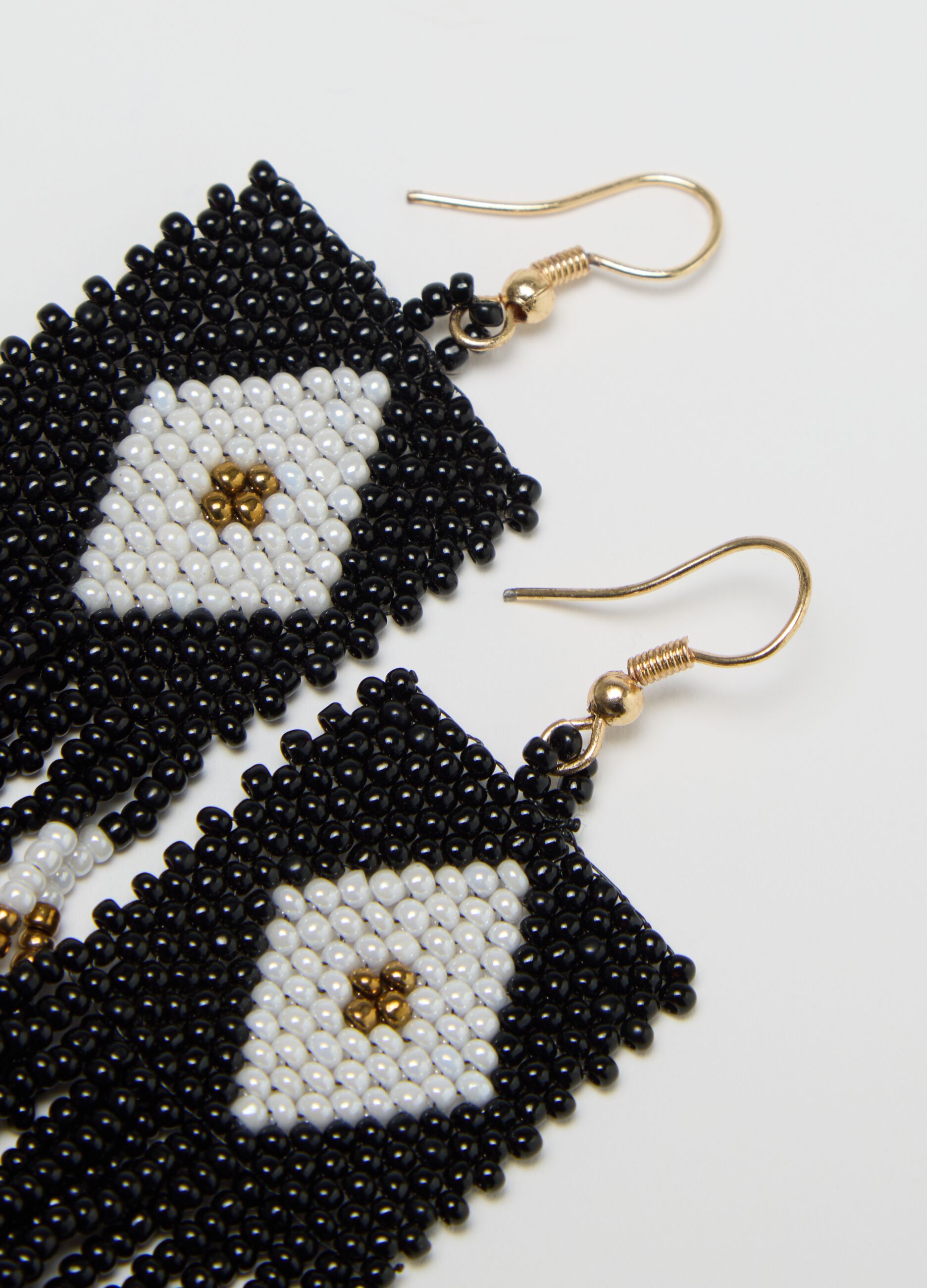 Black and white pendant earrings with beads and fringing