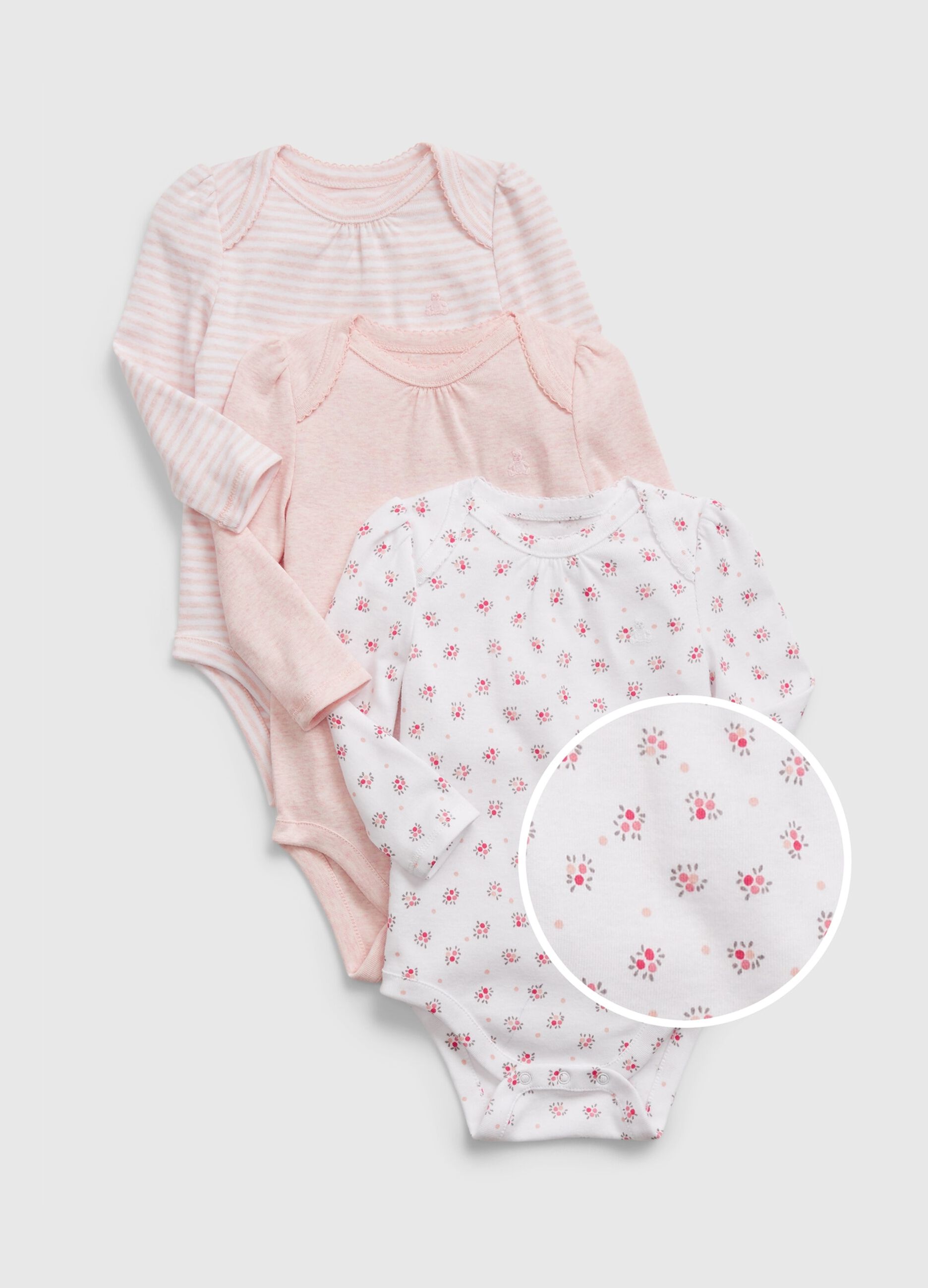 Three-pack cotton bodysuits with long sleeves.