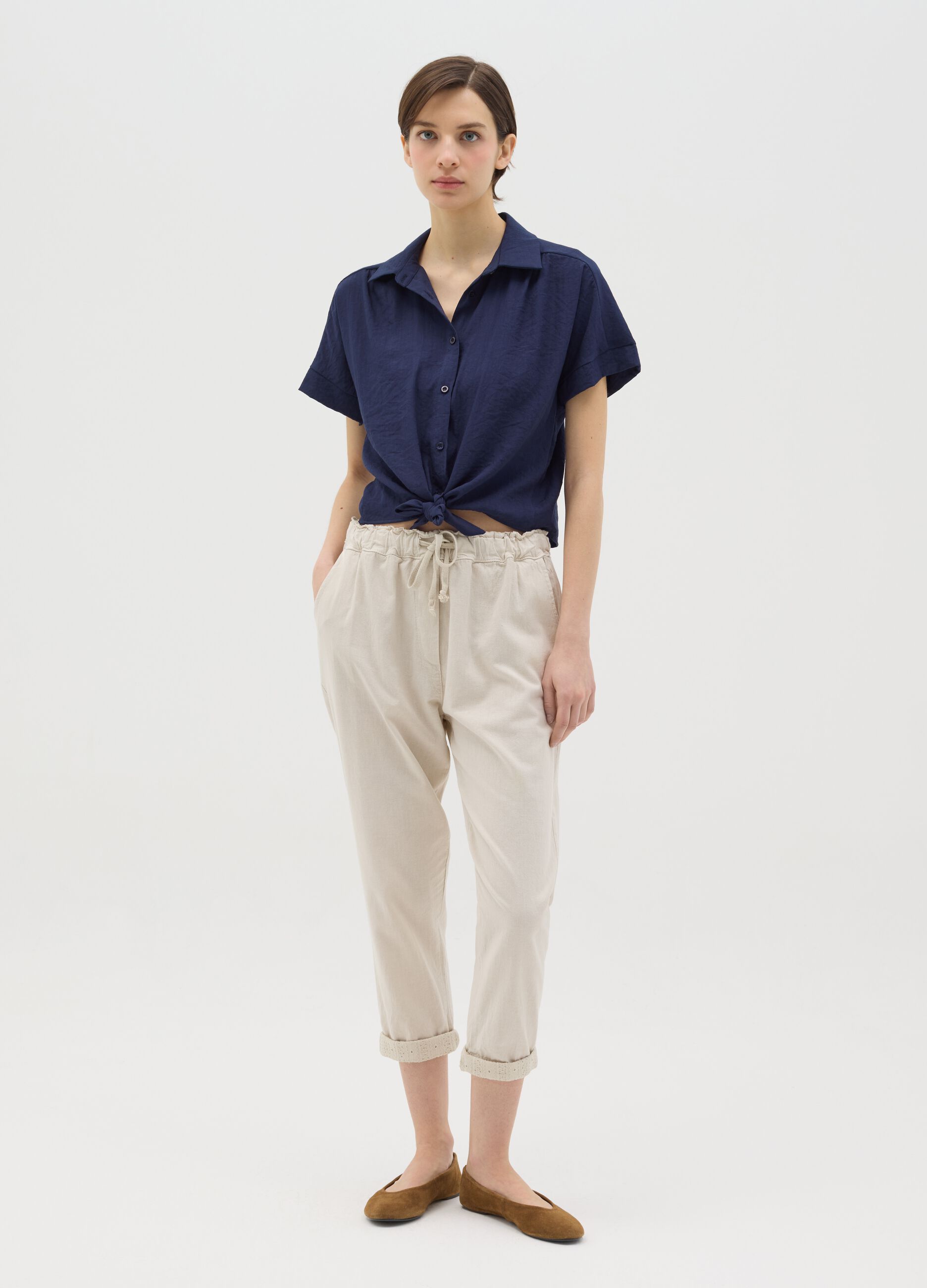 Beige trousers with drawstring and broderie anglaise details