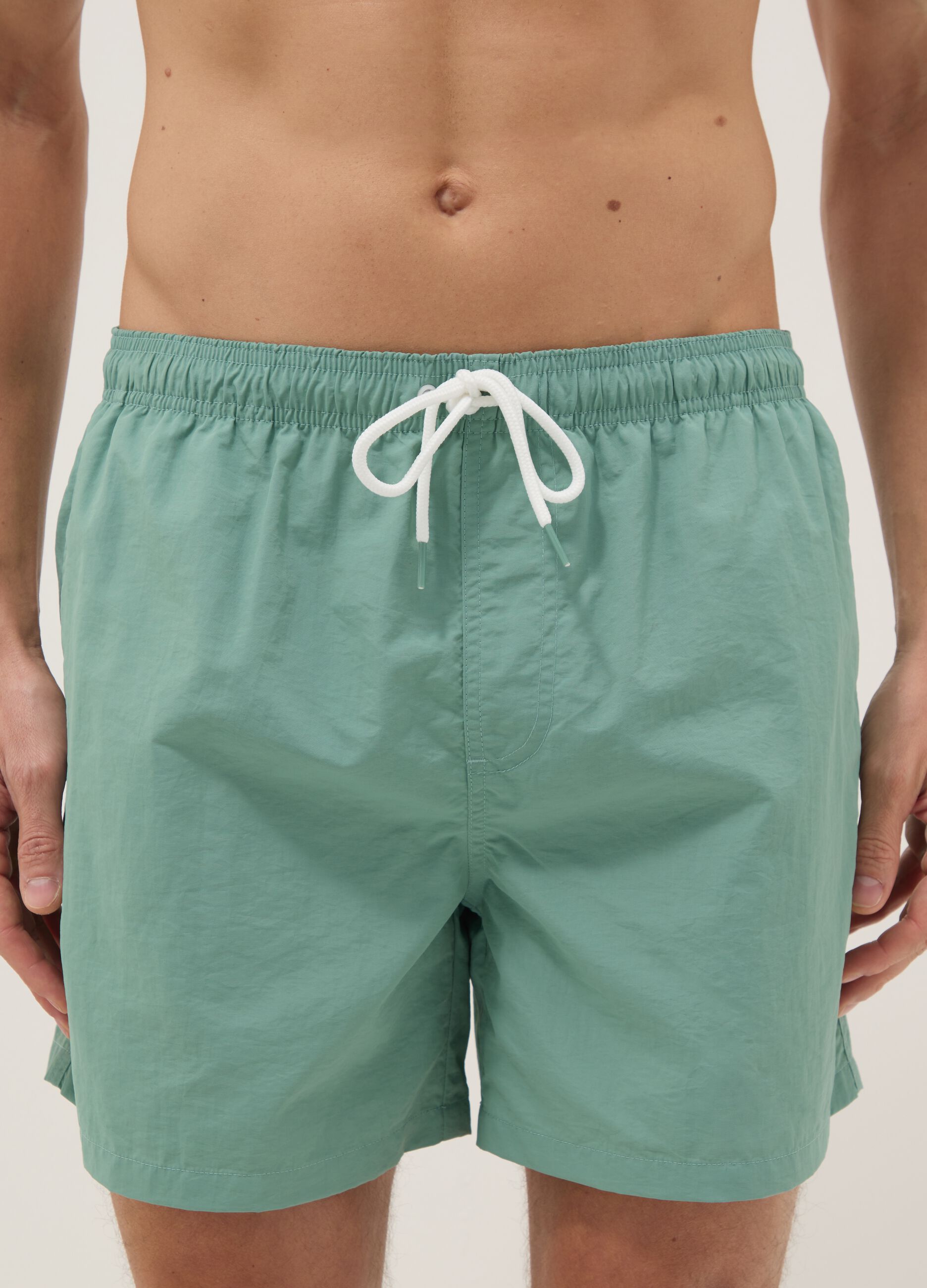 Green swim shorts with elasticated waistband