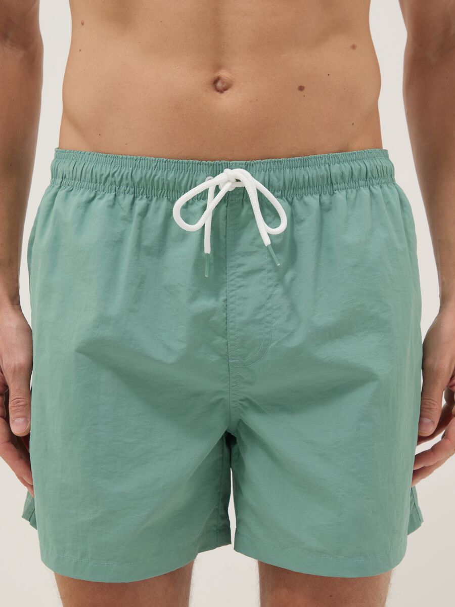 Green swim shorts with elasticated waistband_1
