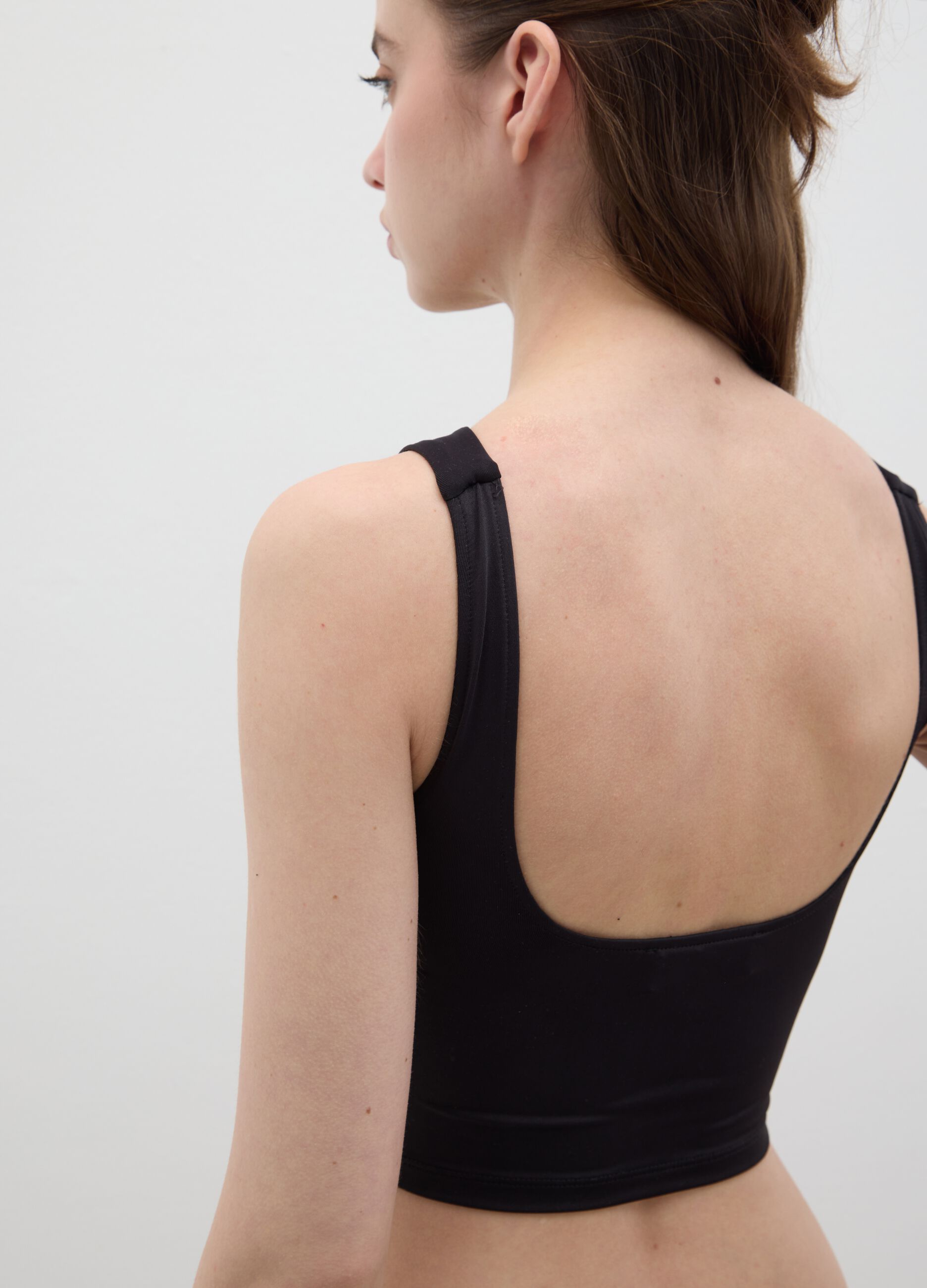 Women’s fitted top in black stretch fabric with wide straps