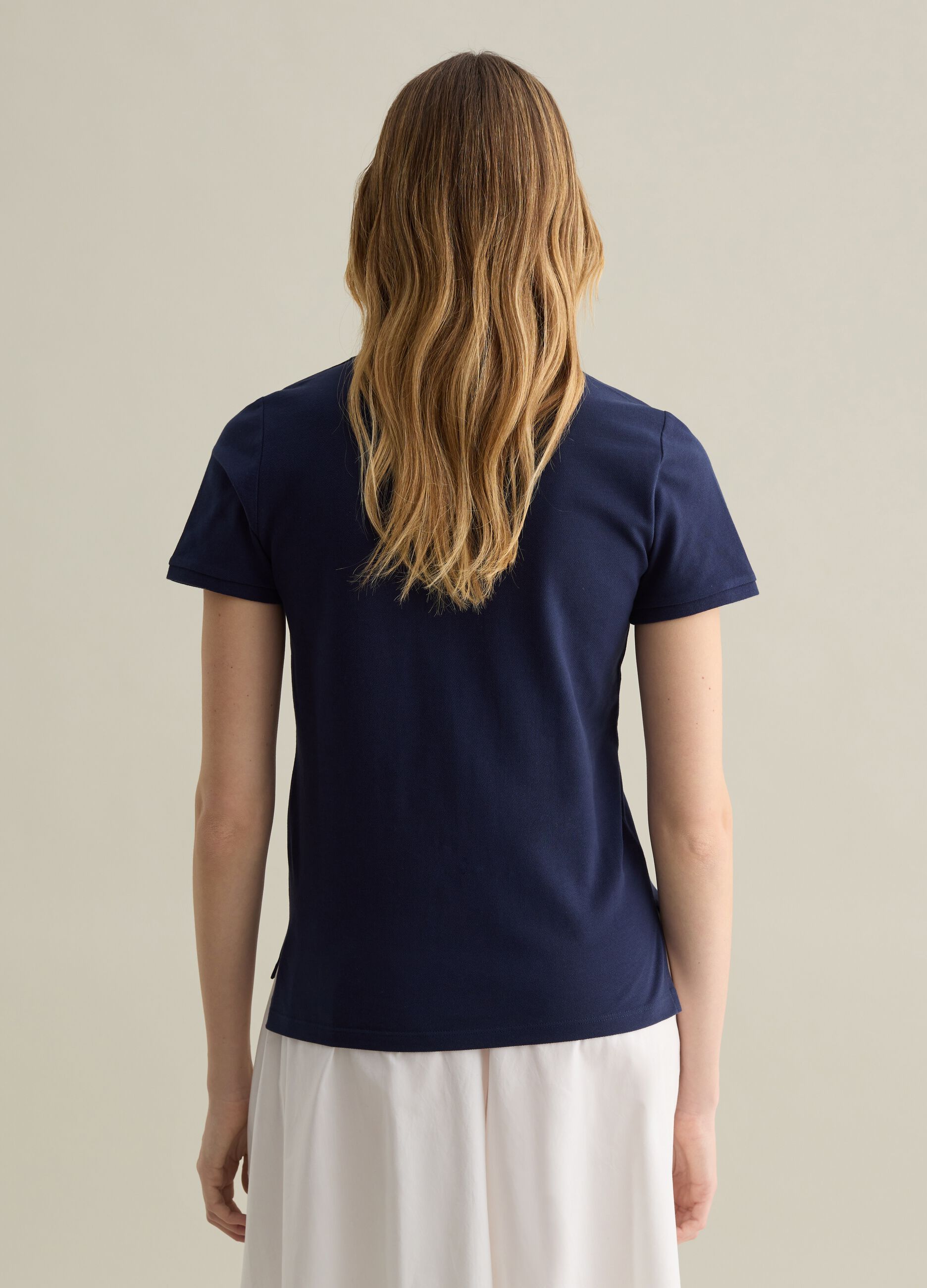 Blue short-sleeved polo shirt in piquet