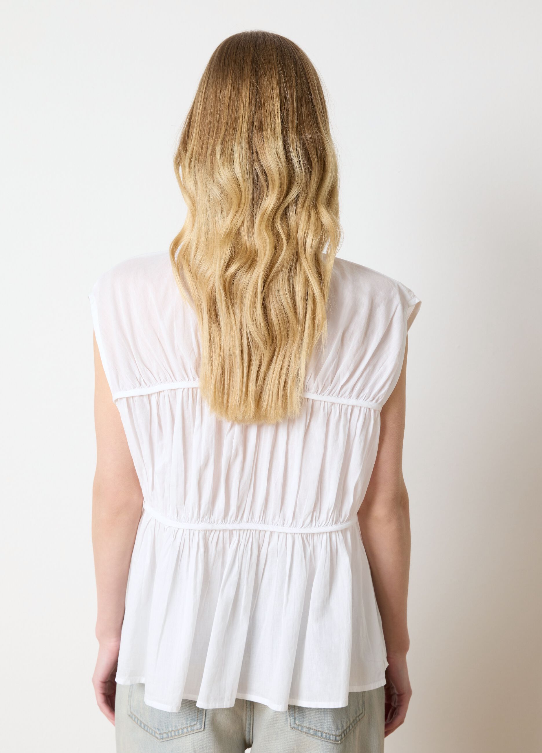 White sleeveless cotton blouse with gathering