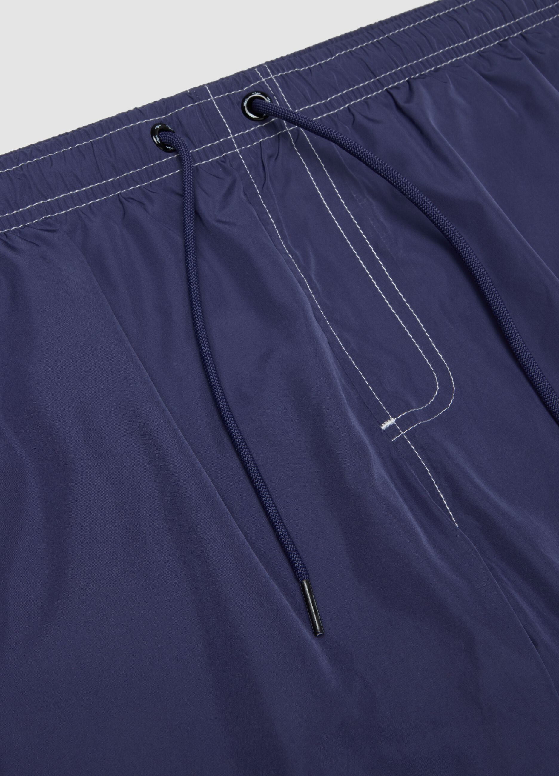 Blue swim shorts with drawstring waist