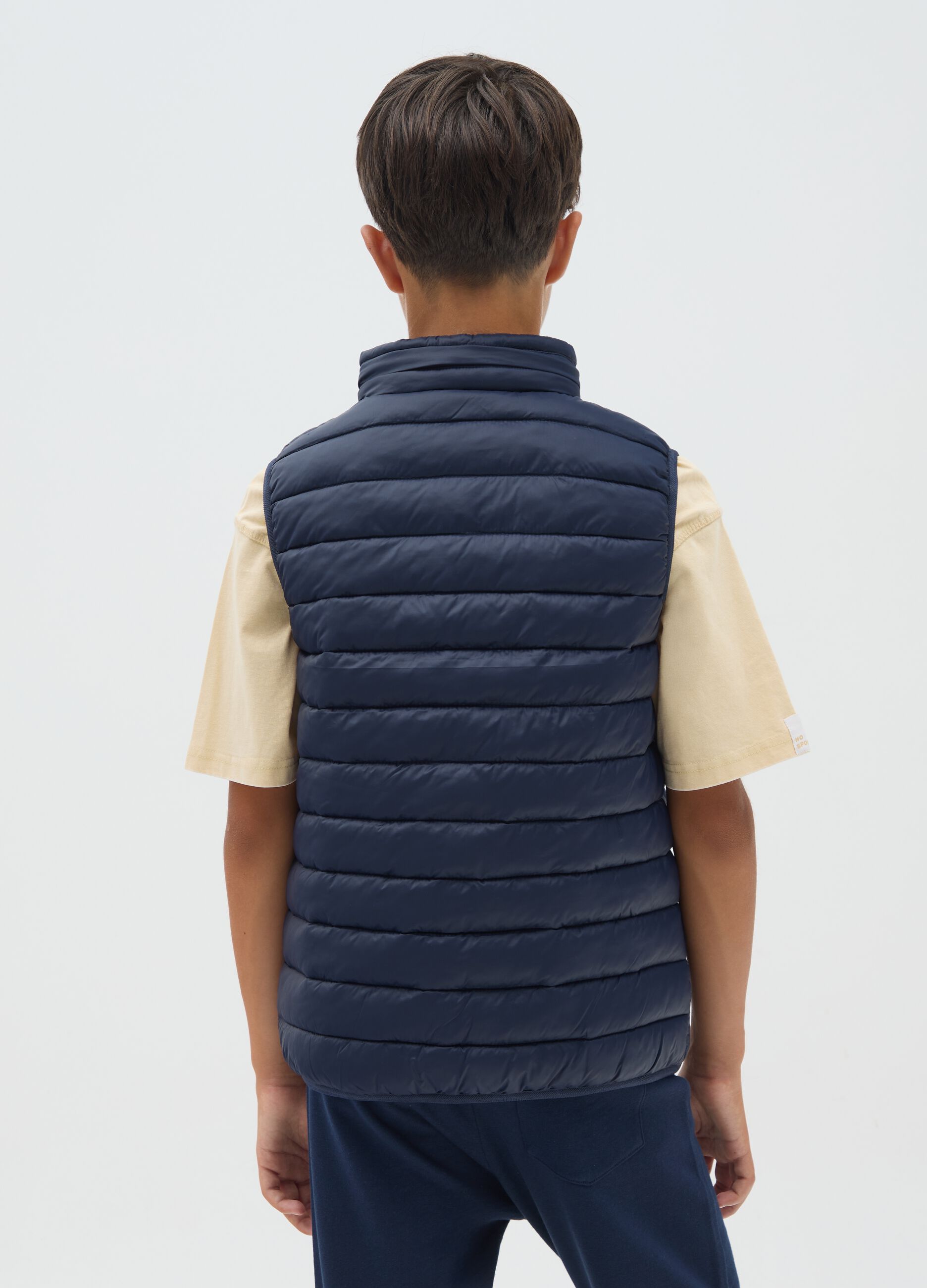 Boy's blue gilet with high collar