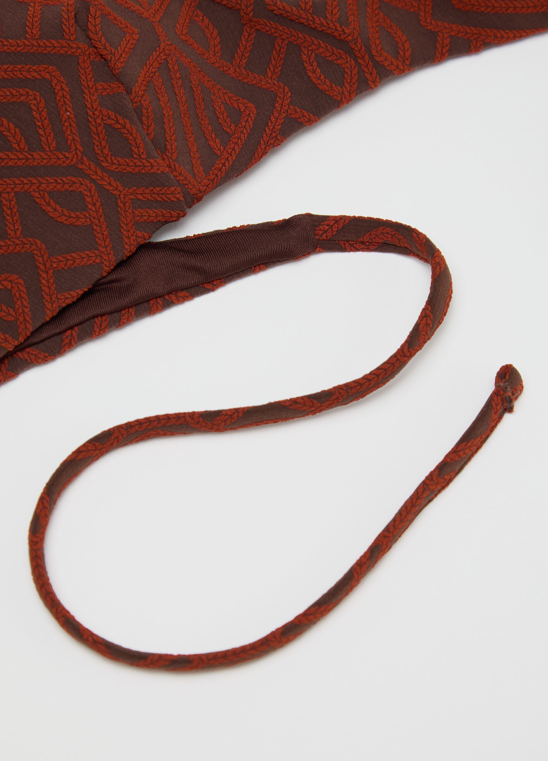 Women’s bikini in brown stretch fabric with geometric texture.