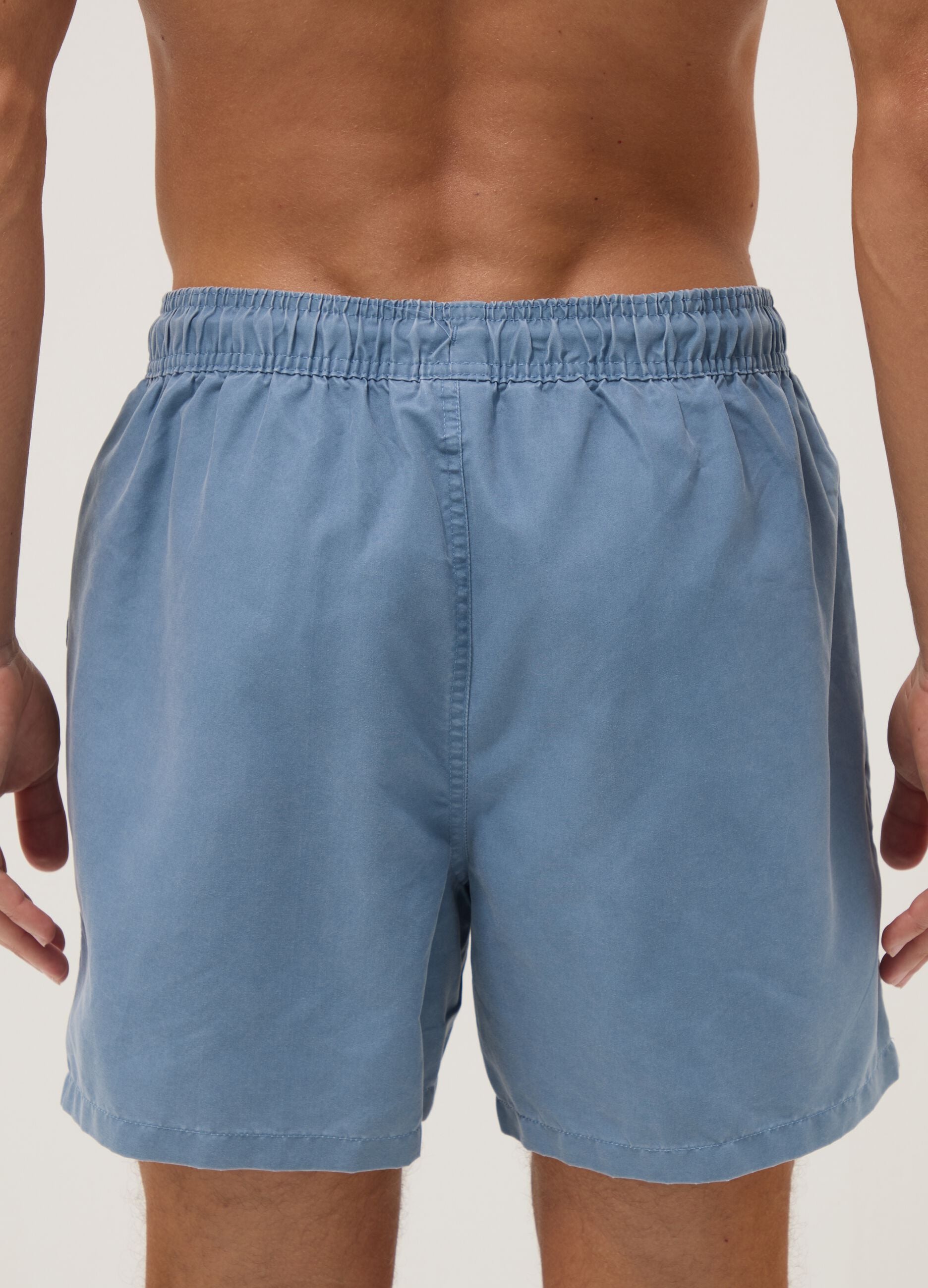 Blue swim shorts with drawstring waist