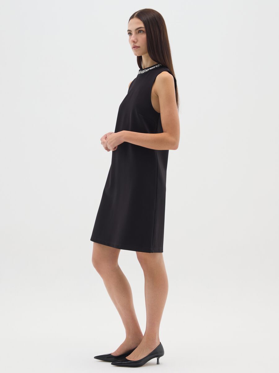 Sleeveless black fitted dress with embellished neckline_1