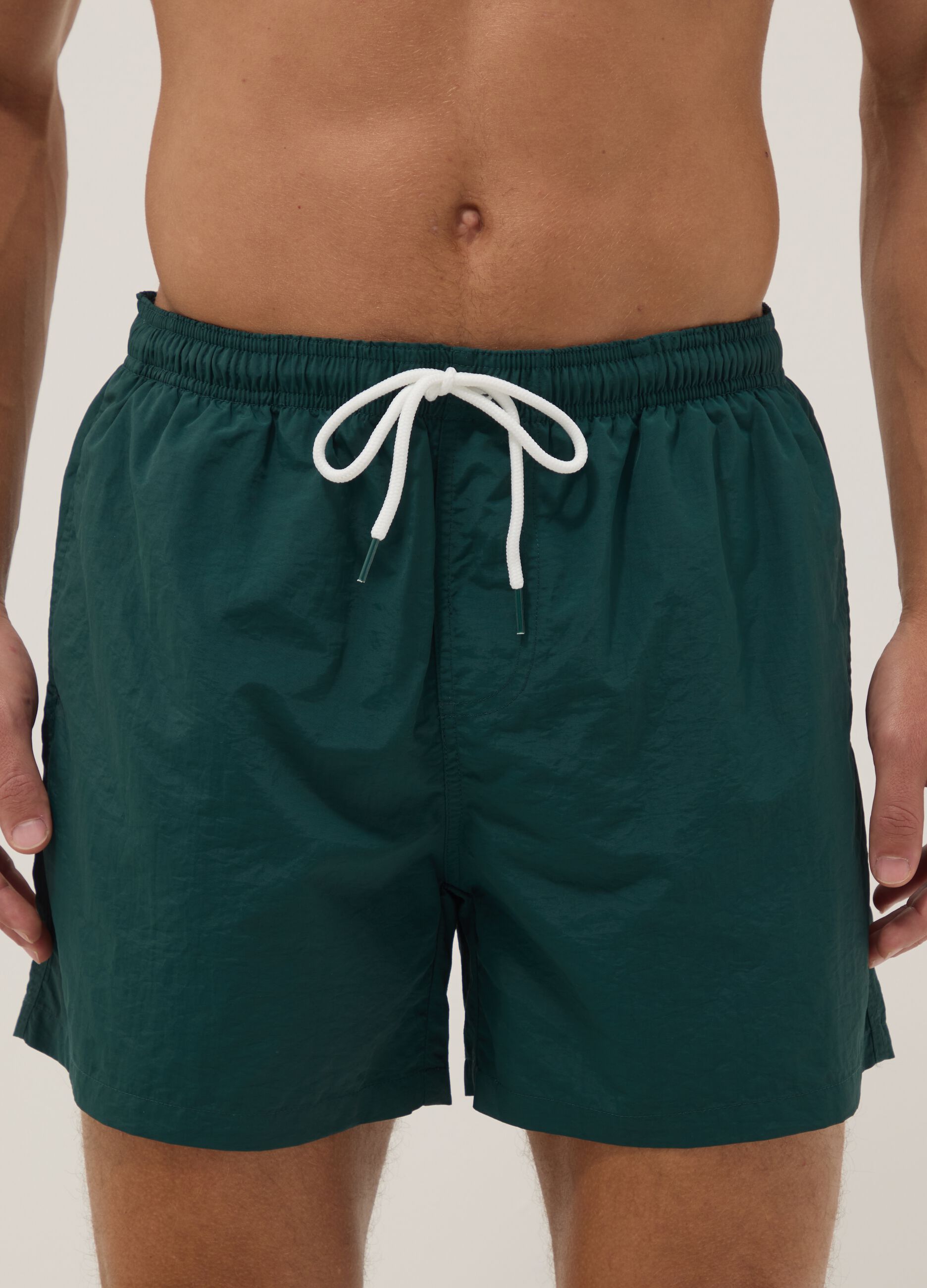 Green swim shorts with elasticated waistband