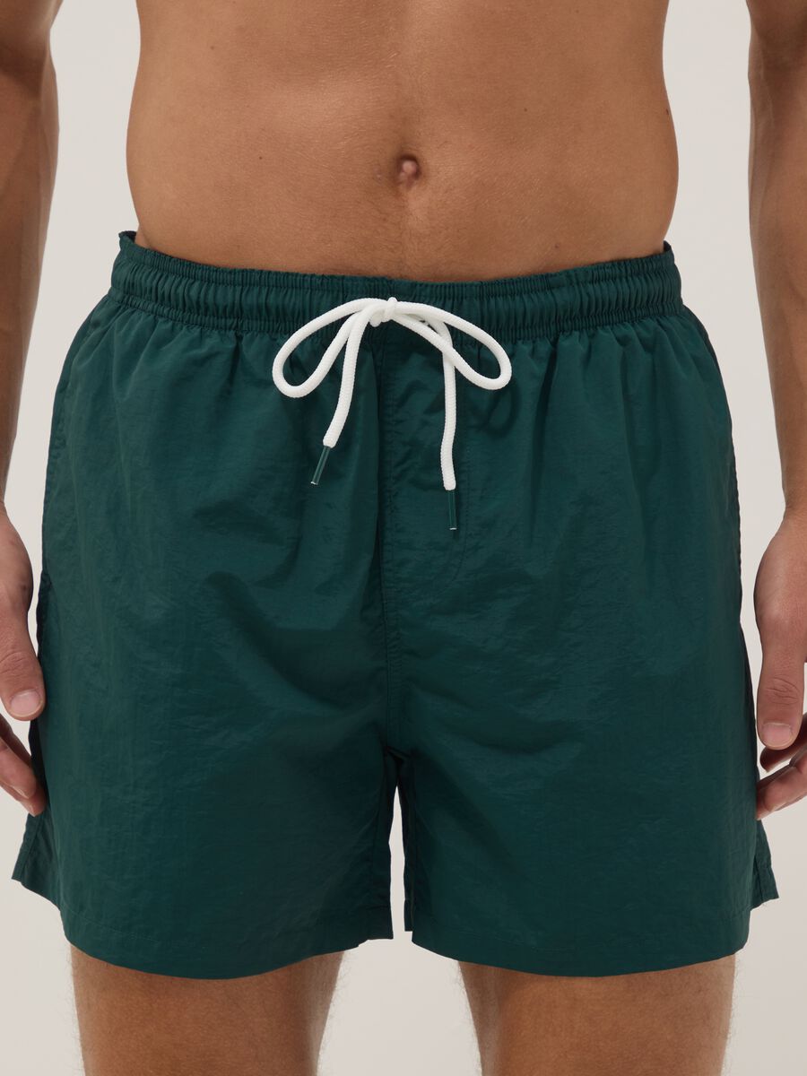 Green swim shorts with elasticated waistband_1